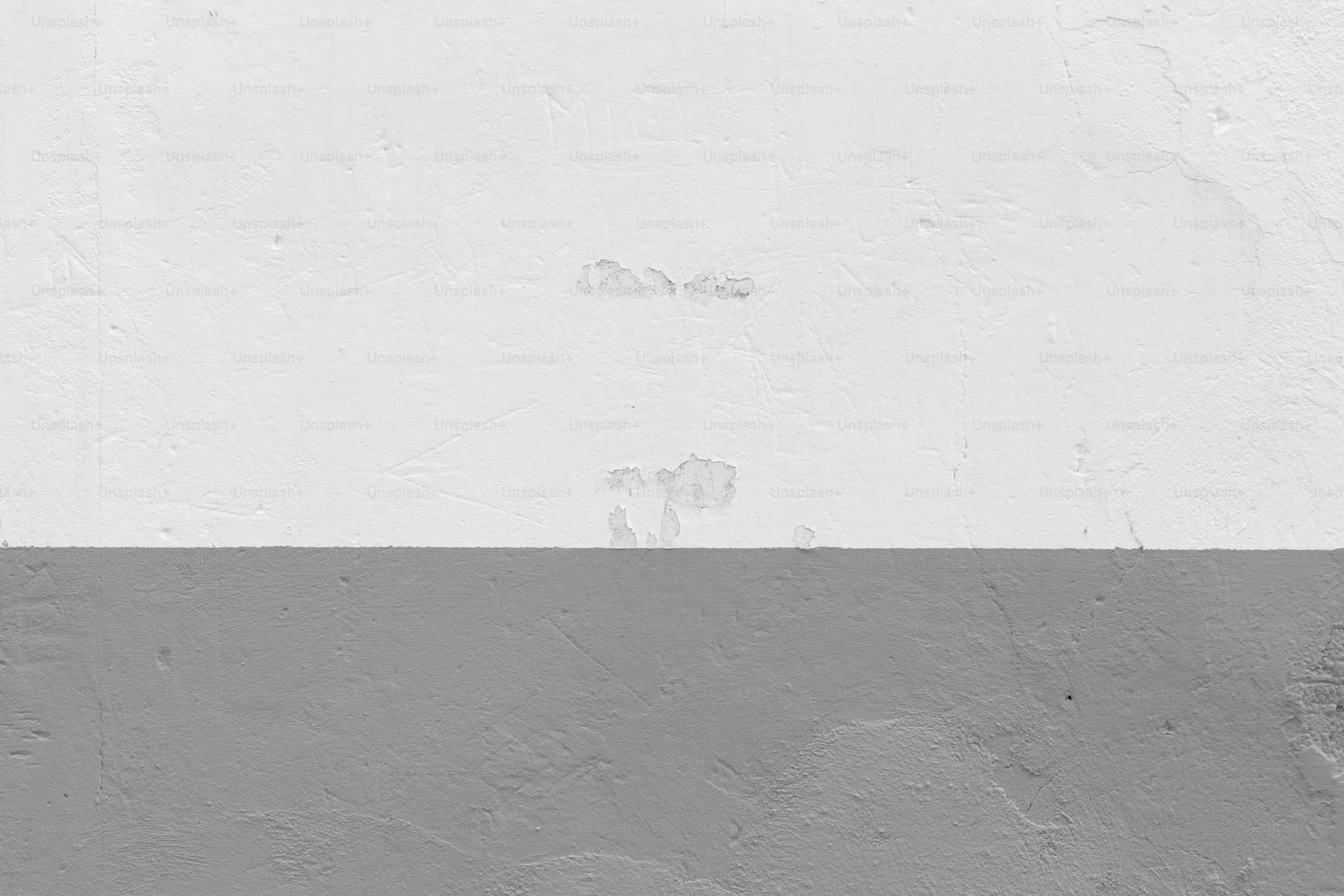 Fondo de pared con textura blanca y gris.