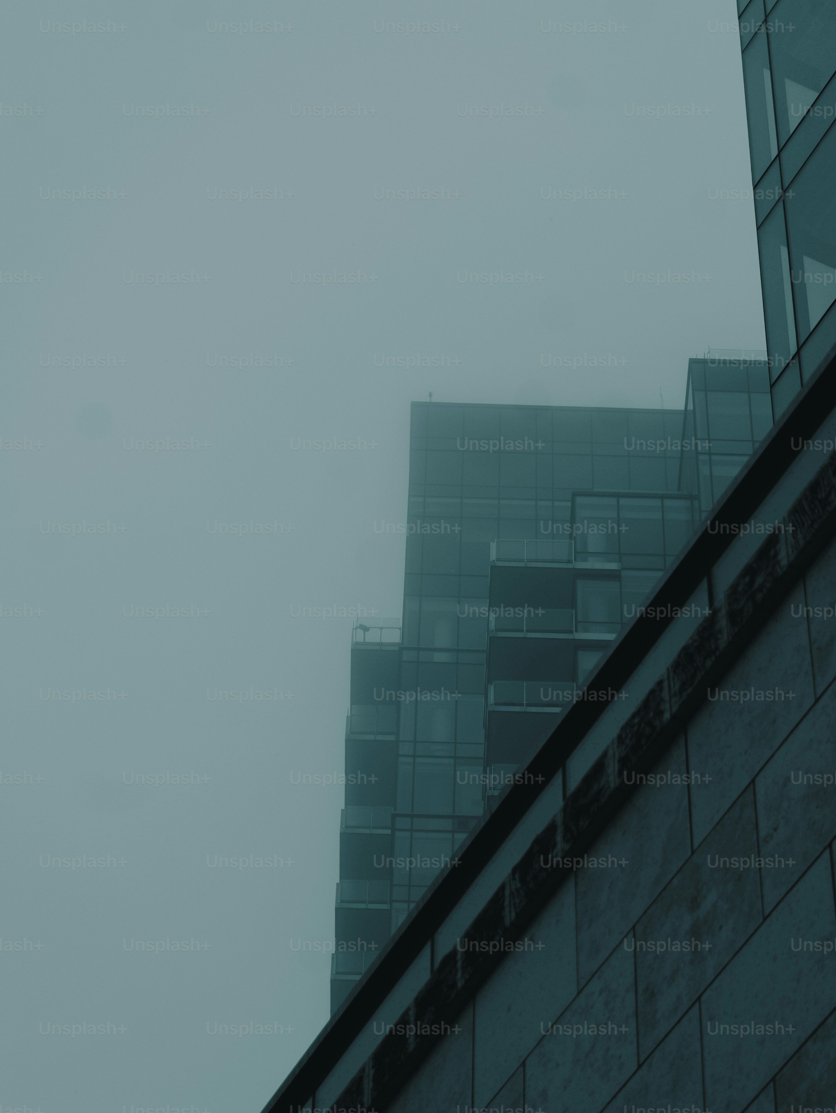 Foggy urban landscape with modern glass buildings.