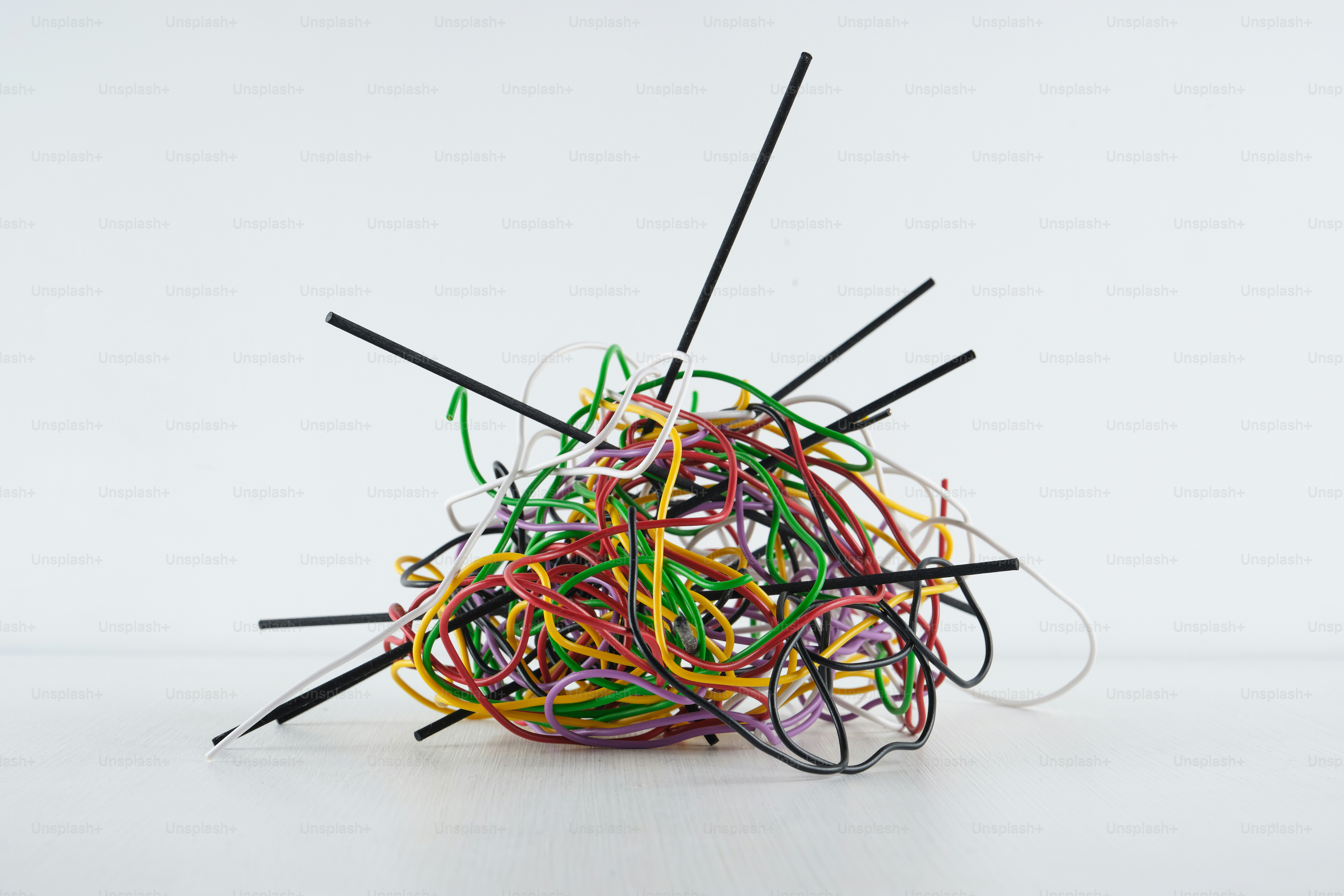 A tangled mess of colorful wires and black sticks. photo – Technology ...