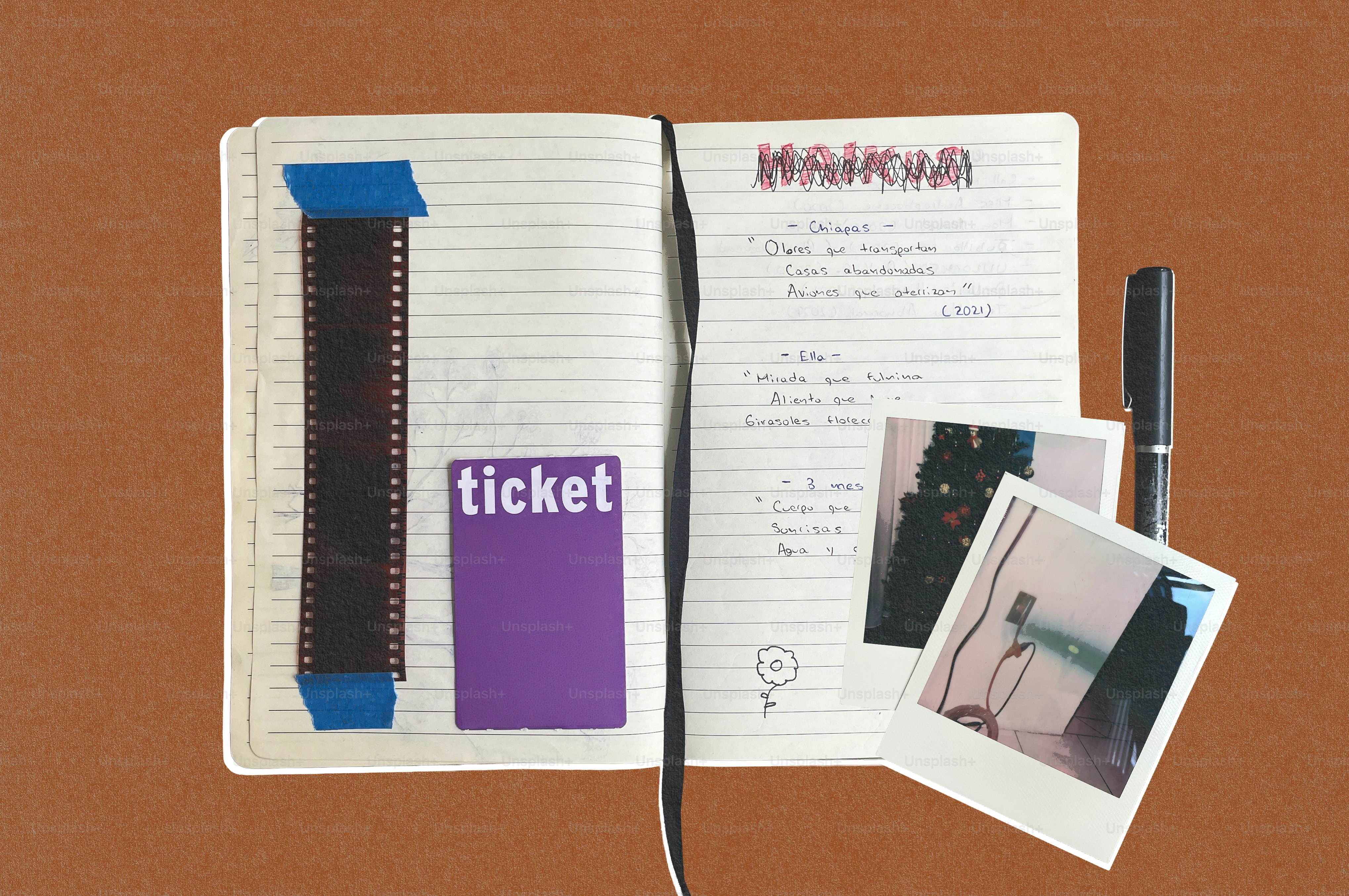 Open notebook with film strip, ticket, pen, and instant photos. photo ...