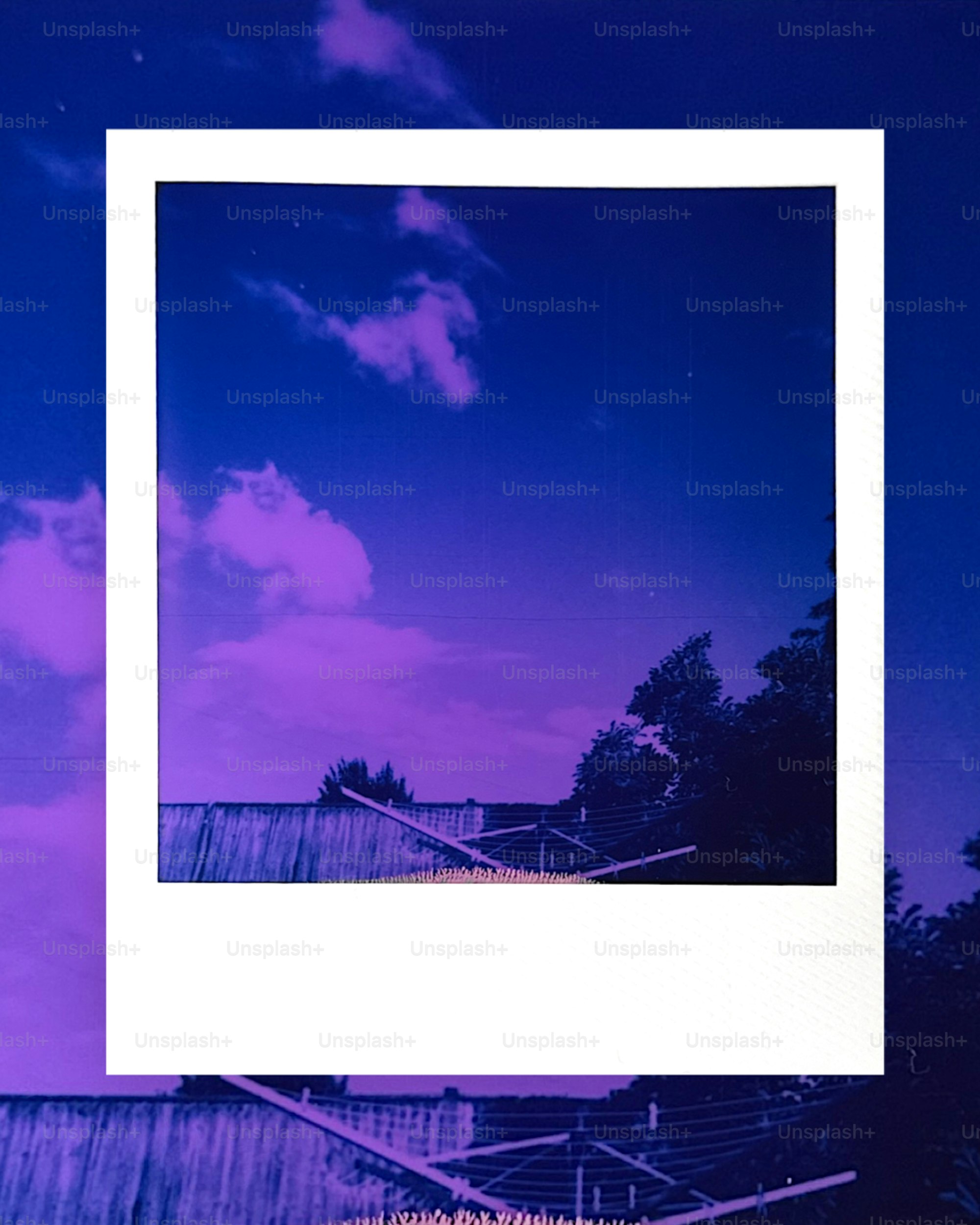 Vibrant purple and blue sky within a white polaroid frame.