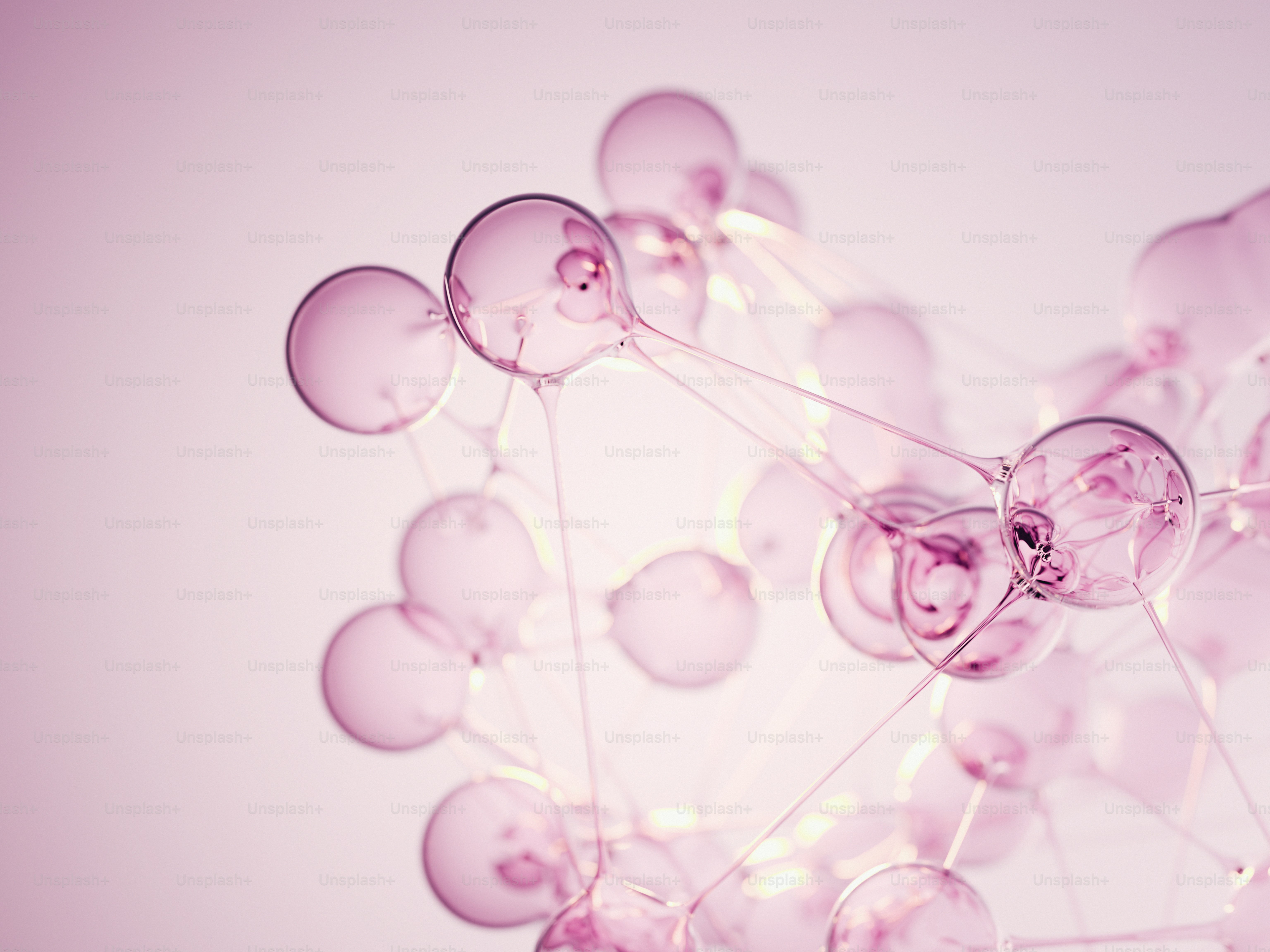 Pink translucent spheres forming an abstract molecular structure.