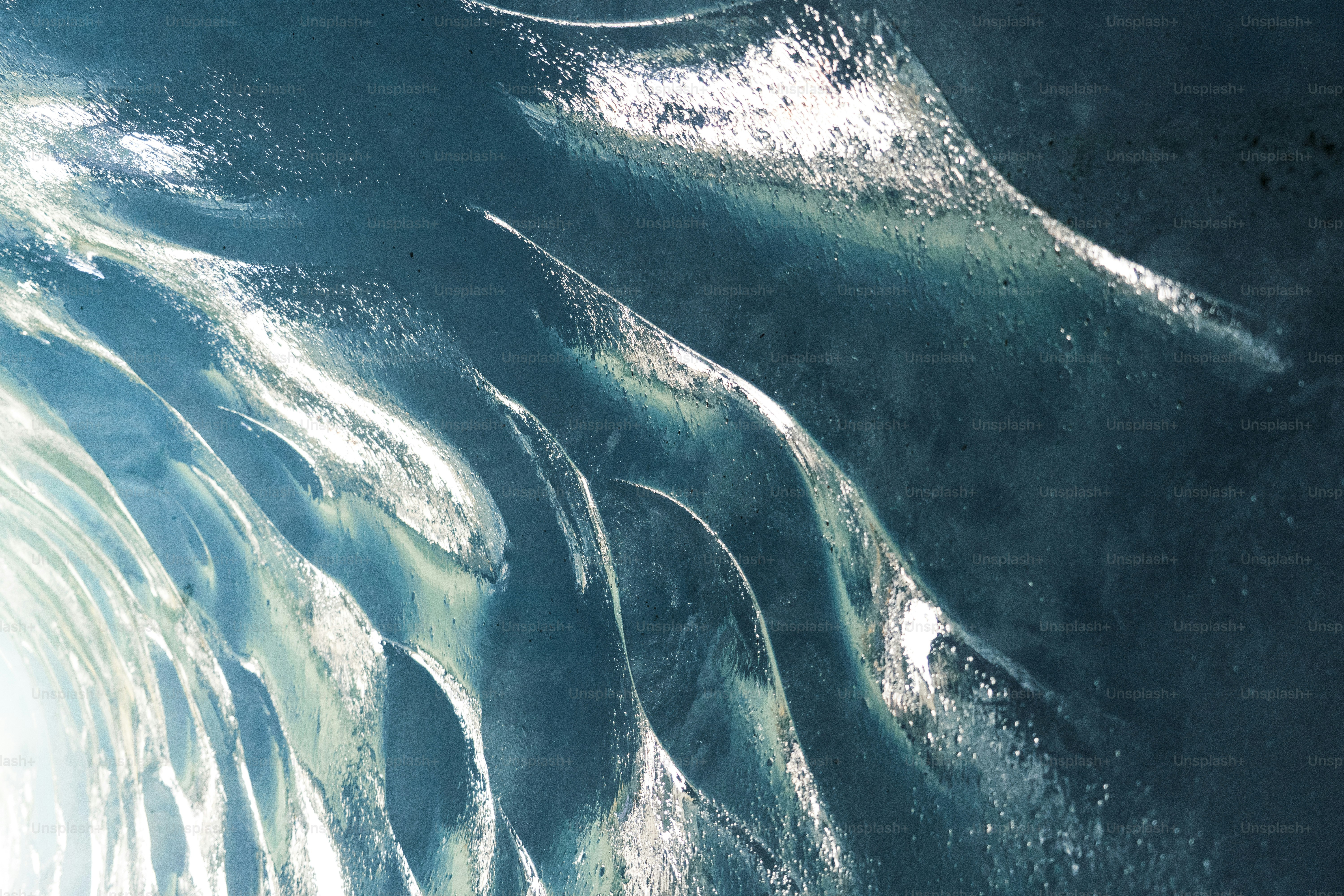 Abstract patterns of blue ice with white highlights.