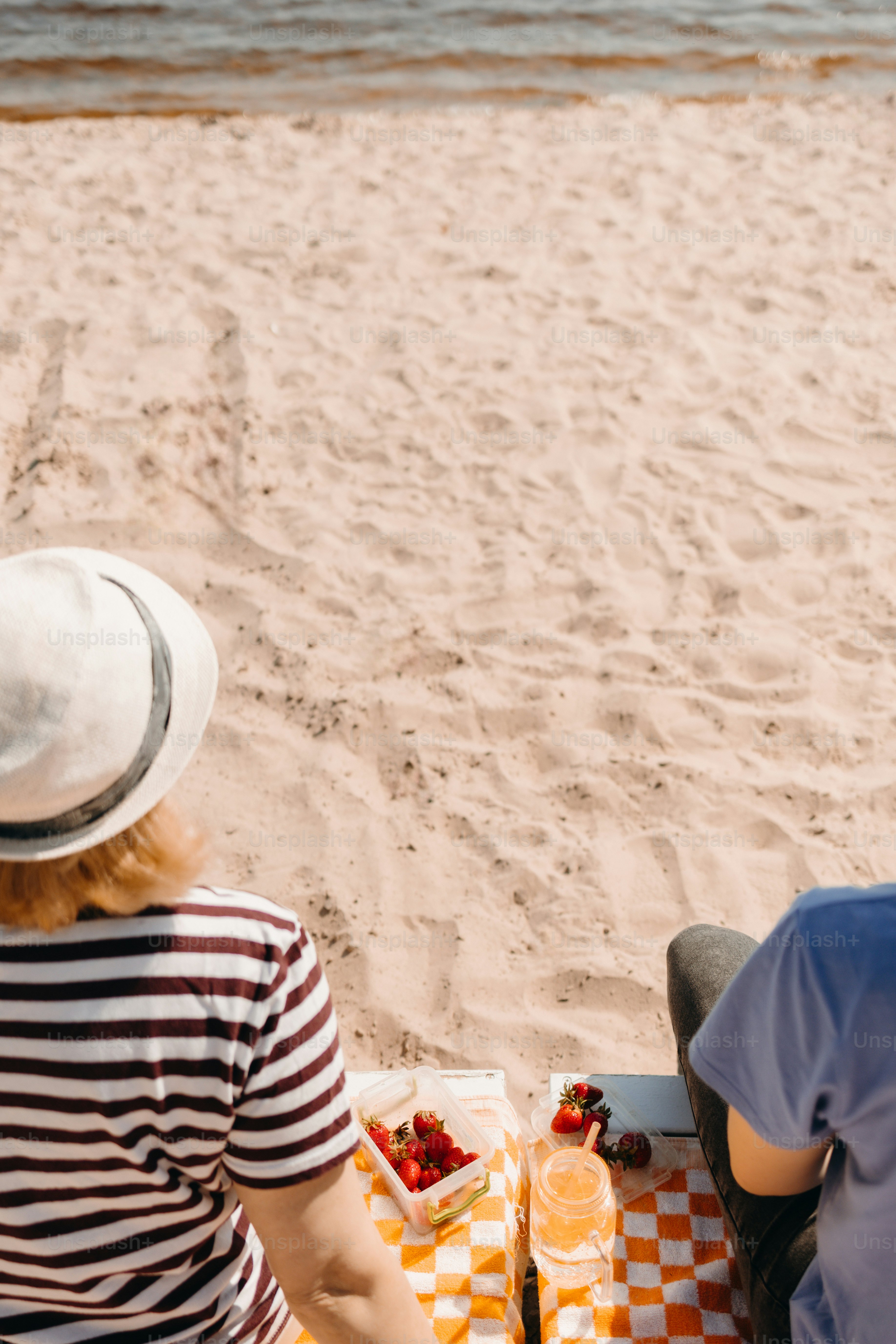 People enjoying a picnic on a sandy beach.