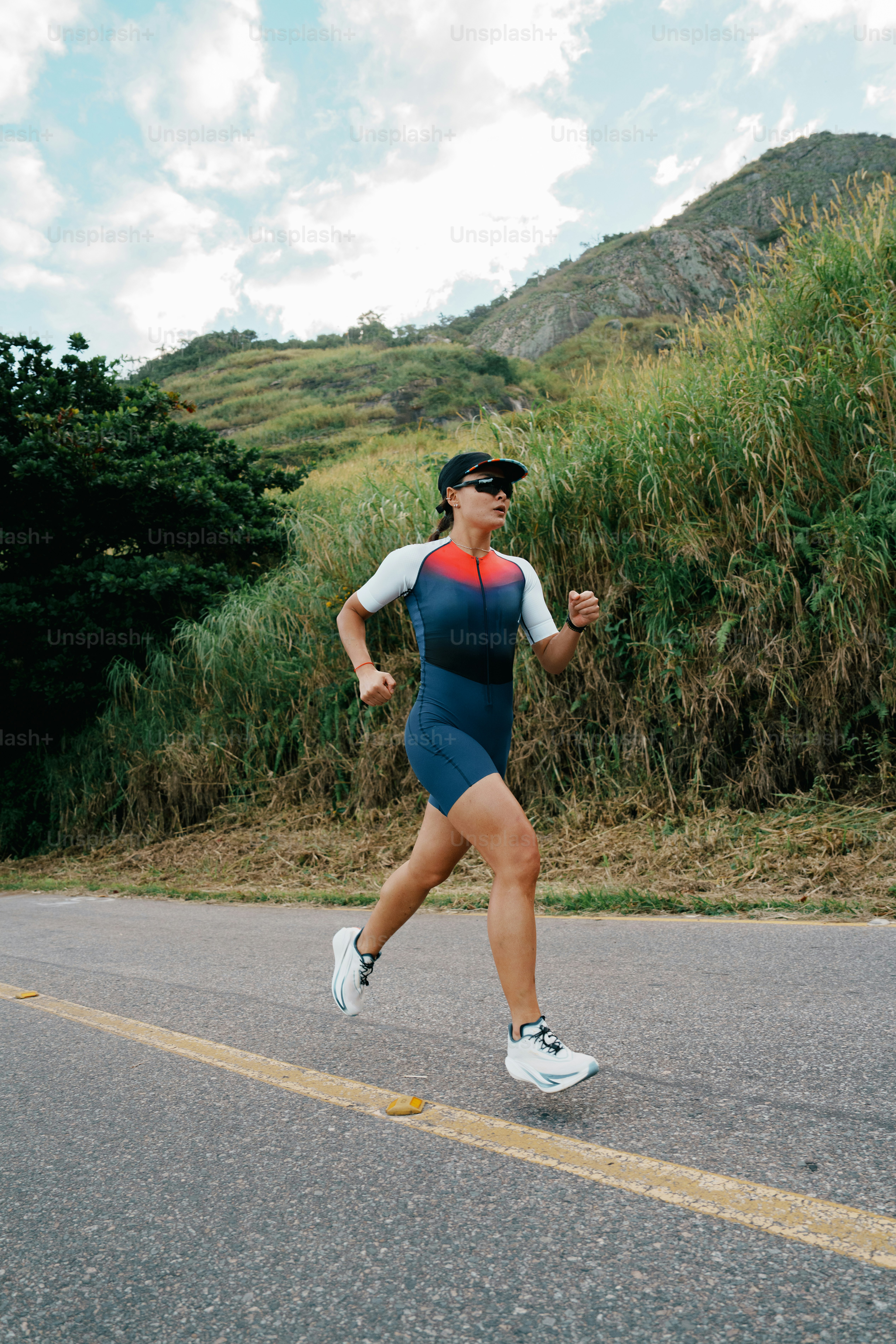 Female runner exercising on a mountain road.