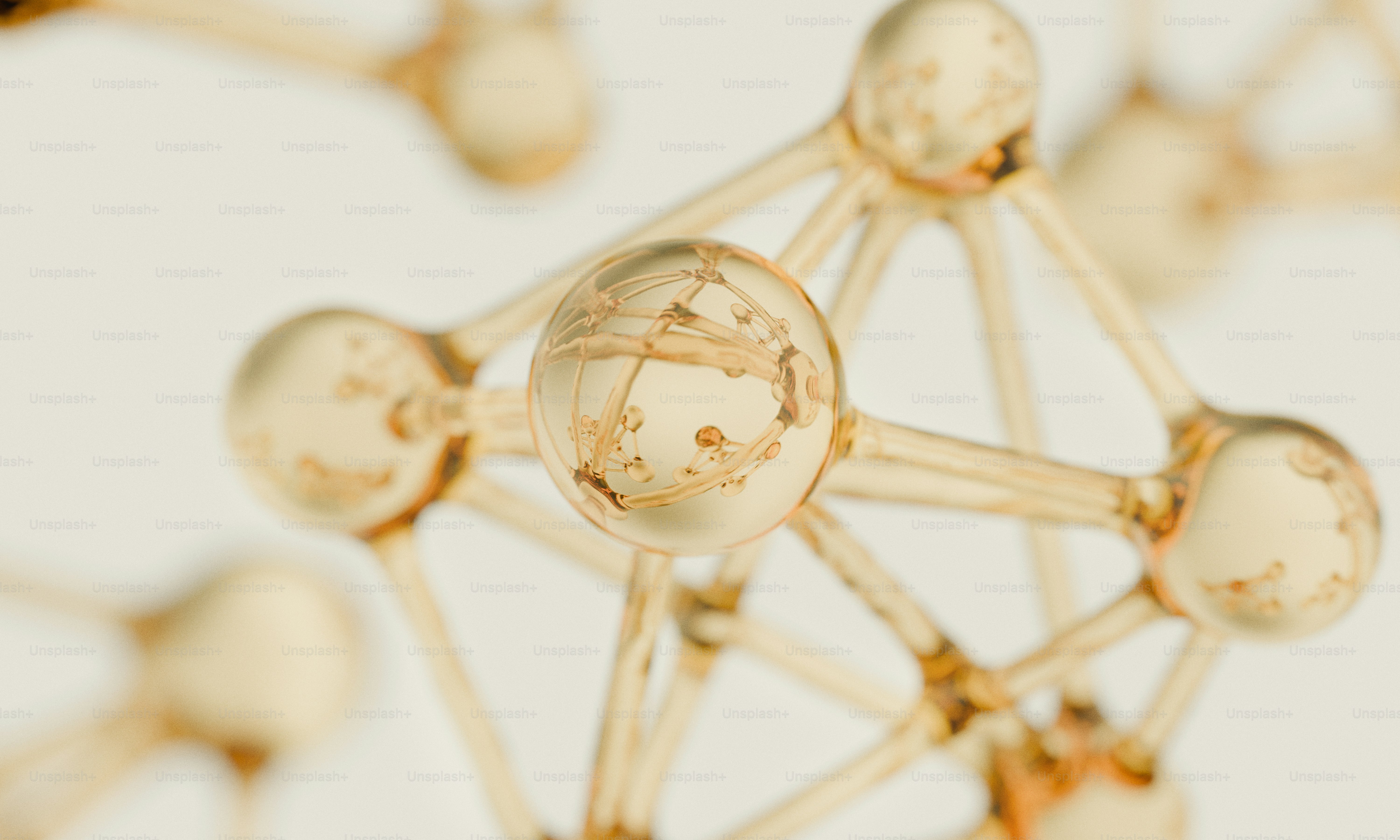 Golden spherical molecular model on a white background.