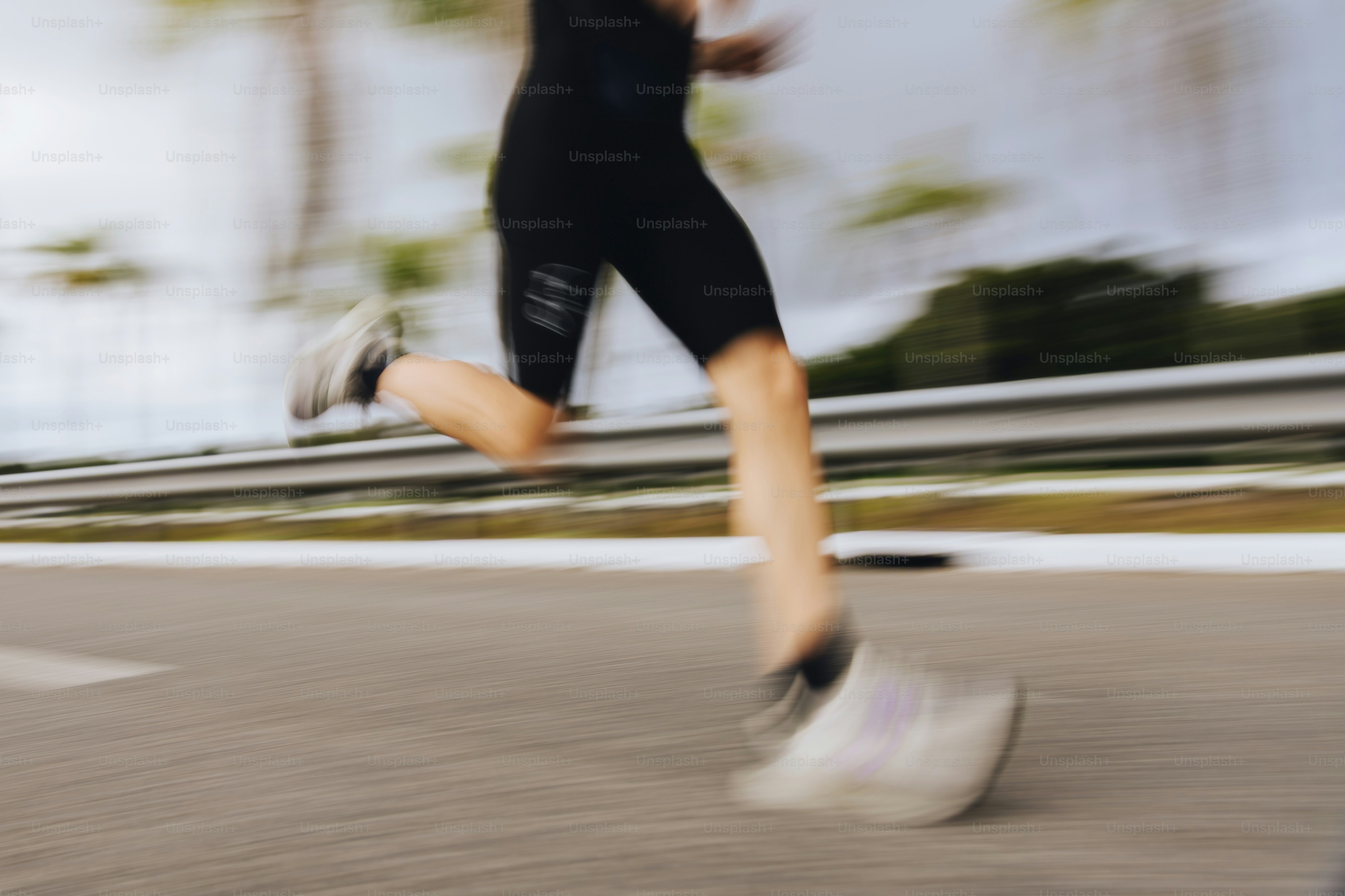 A person running with motion blur on a road.