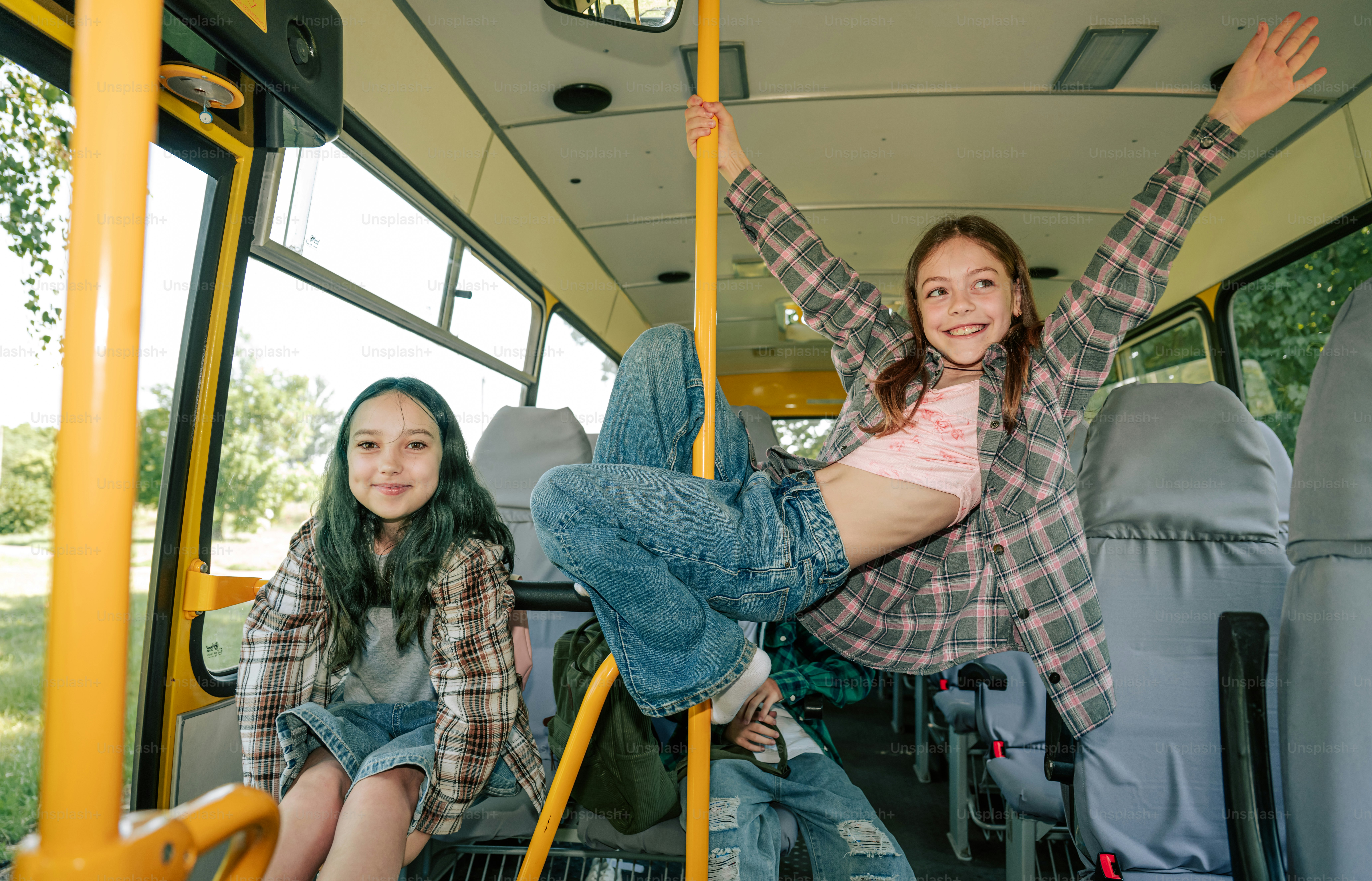 Two happy girls playing inside a bus