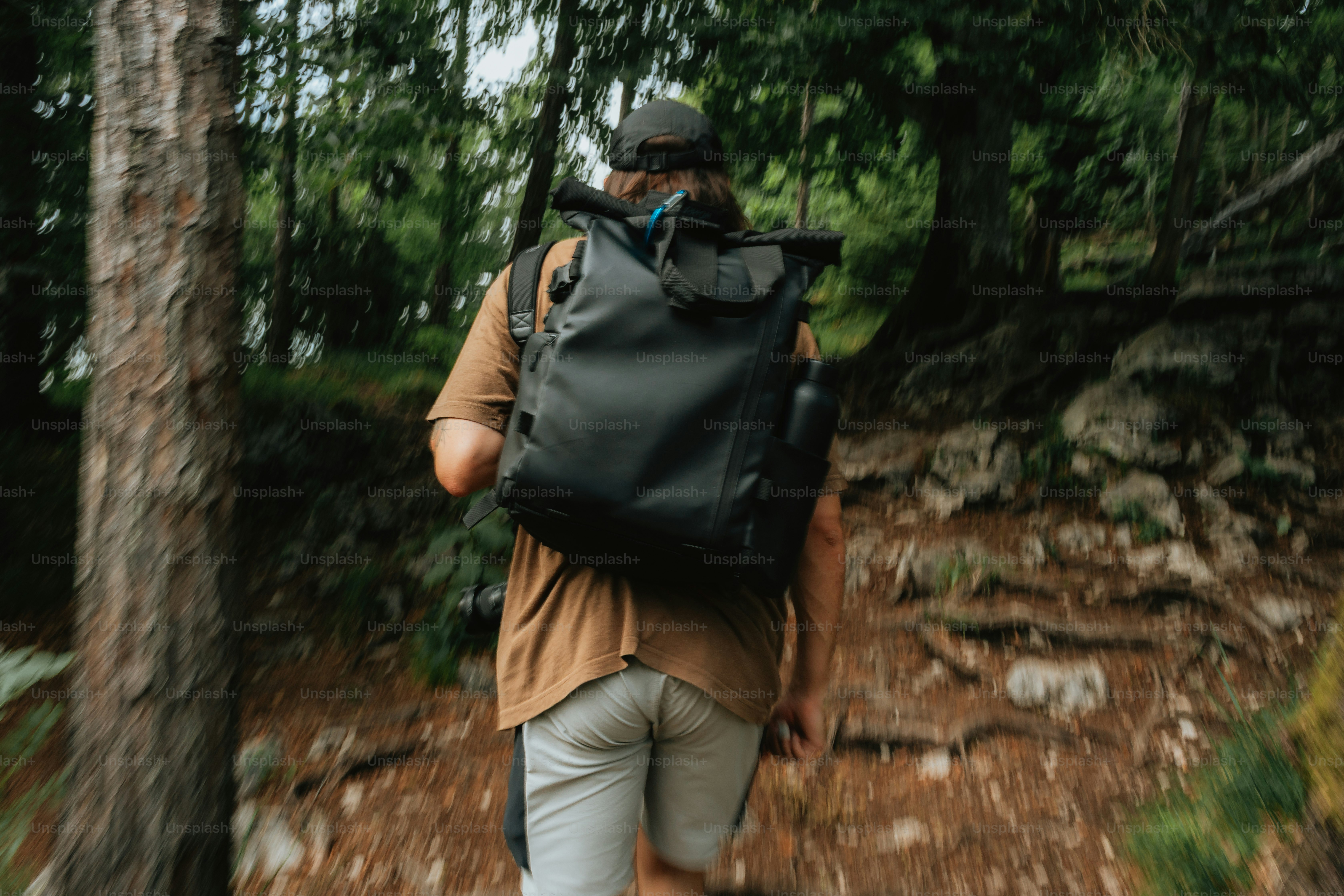 Eine Person mit einem Rucksack geht durch einen Wald