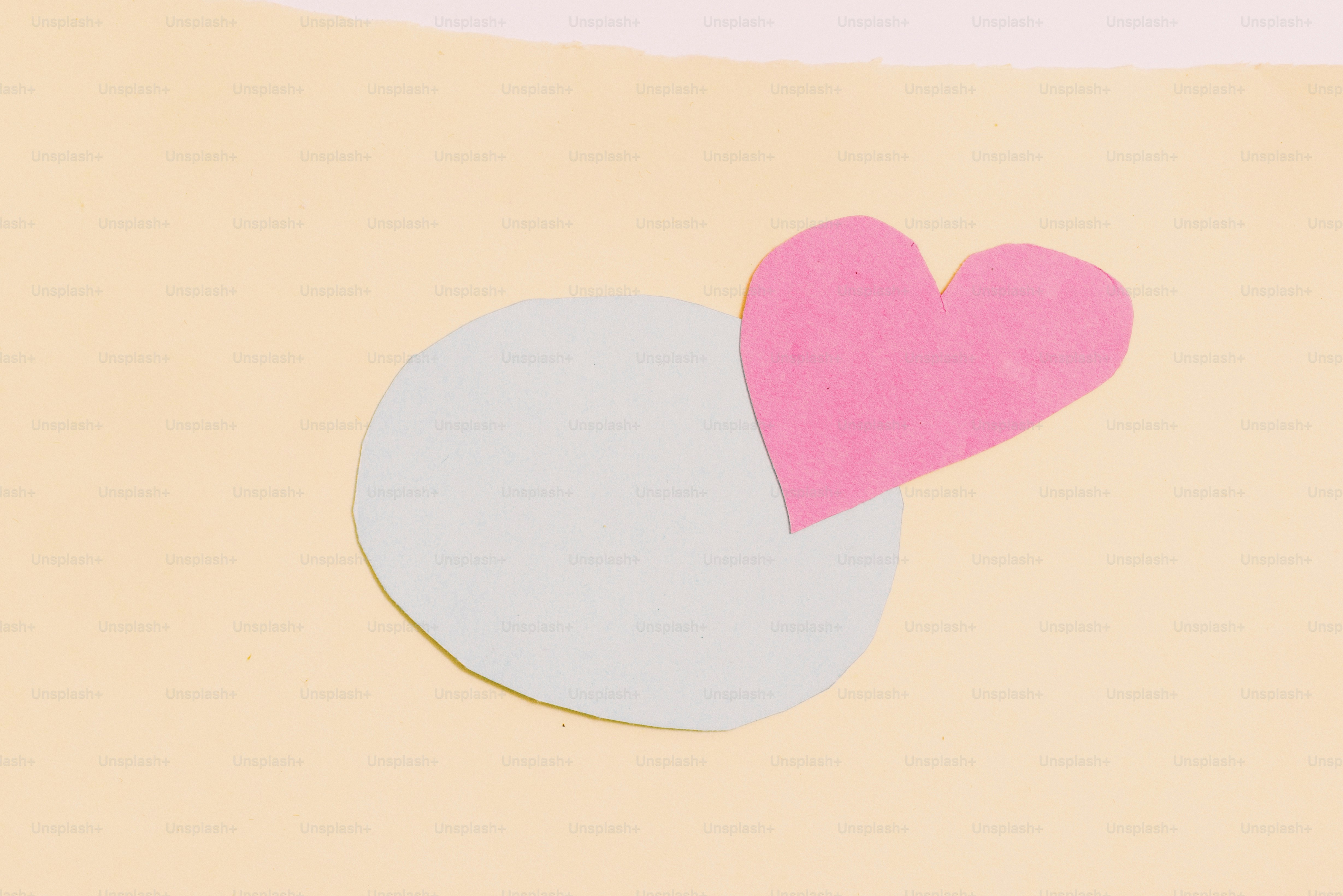 Light gray circle and pink heart on a yellow background.