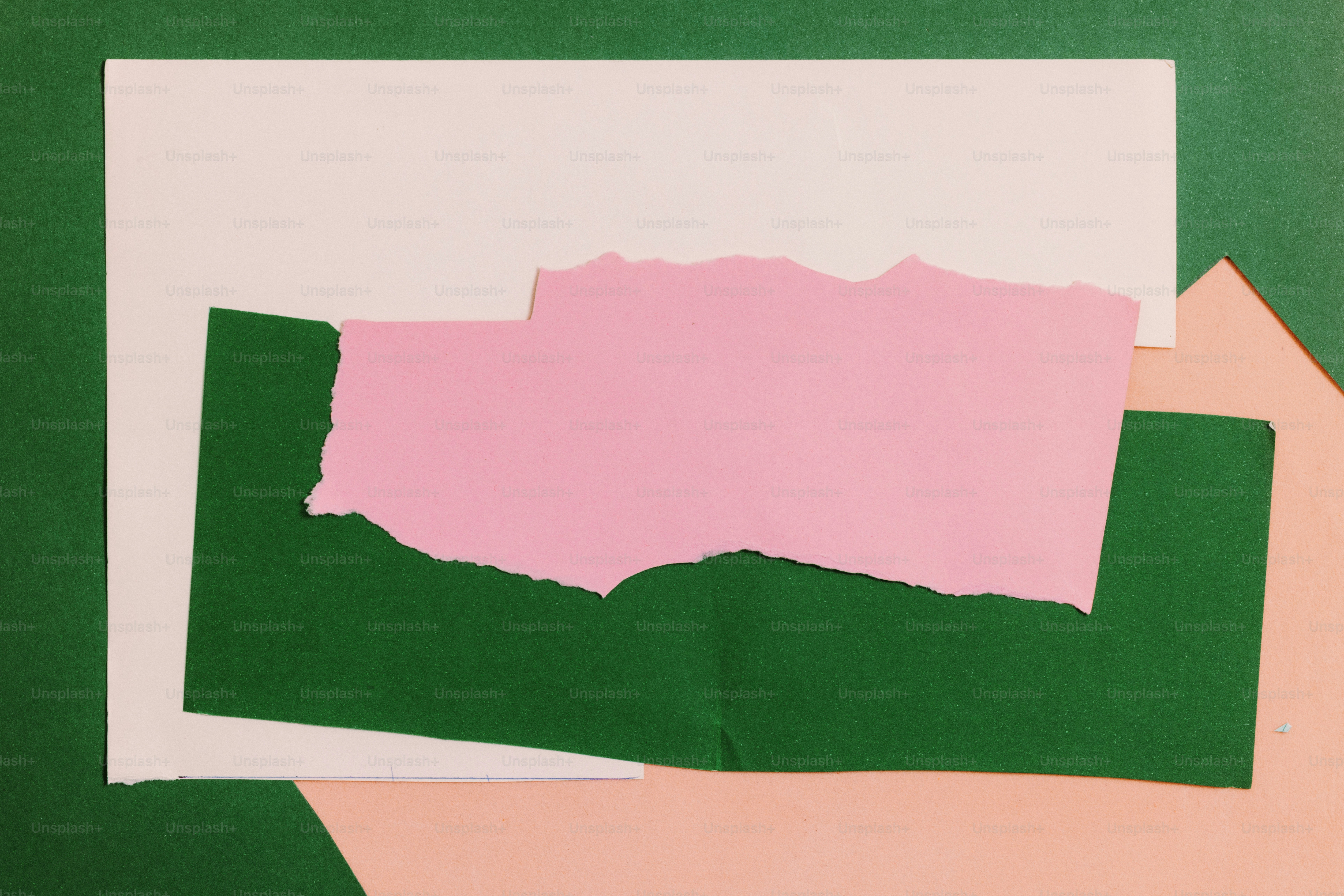 A collage of white, green, pink, and peach colored paper.