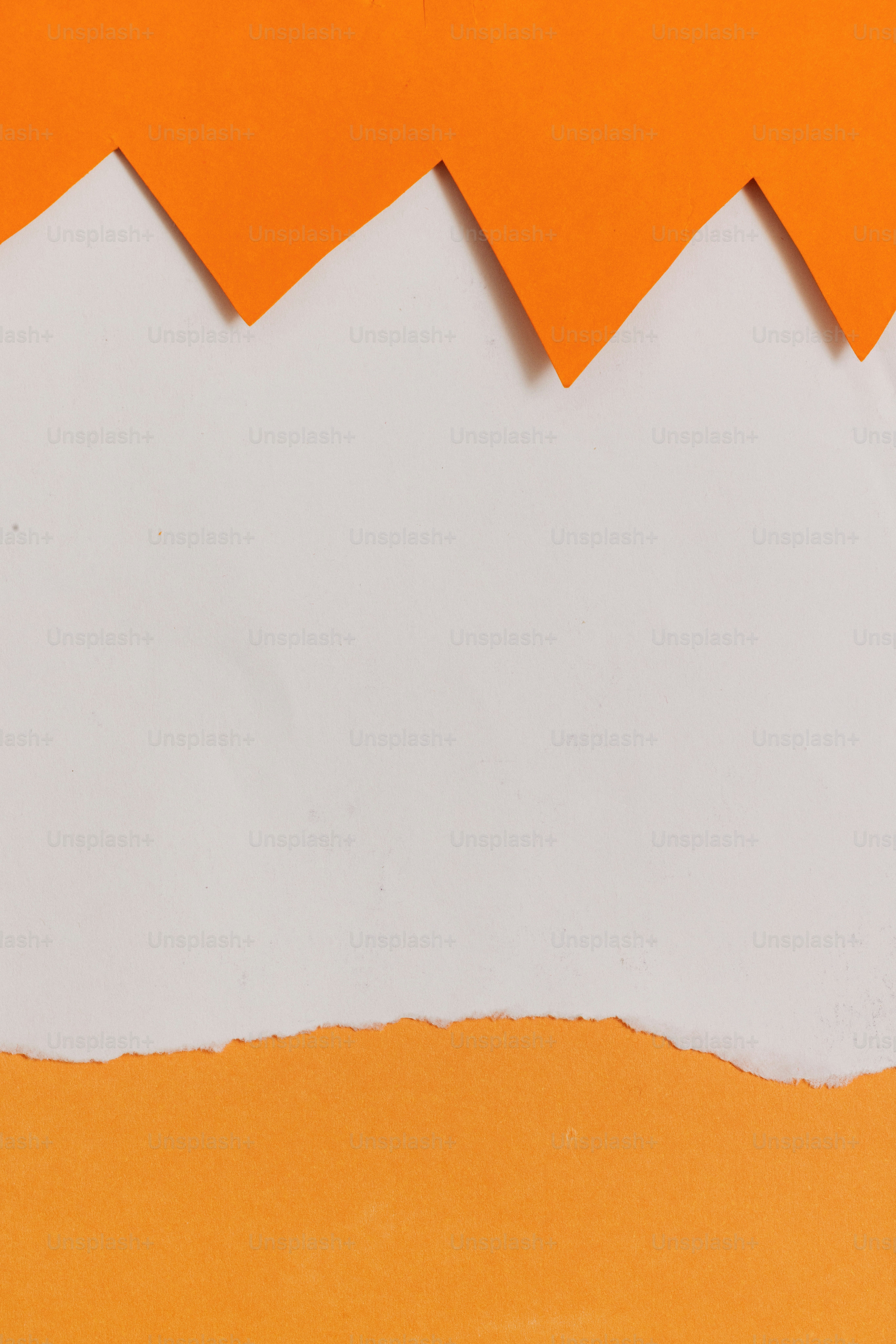 White background with orange zig-zag and torn paper borders.