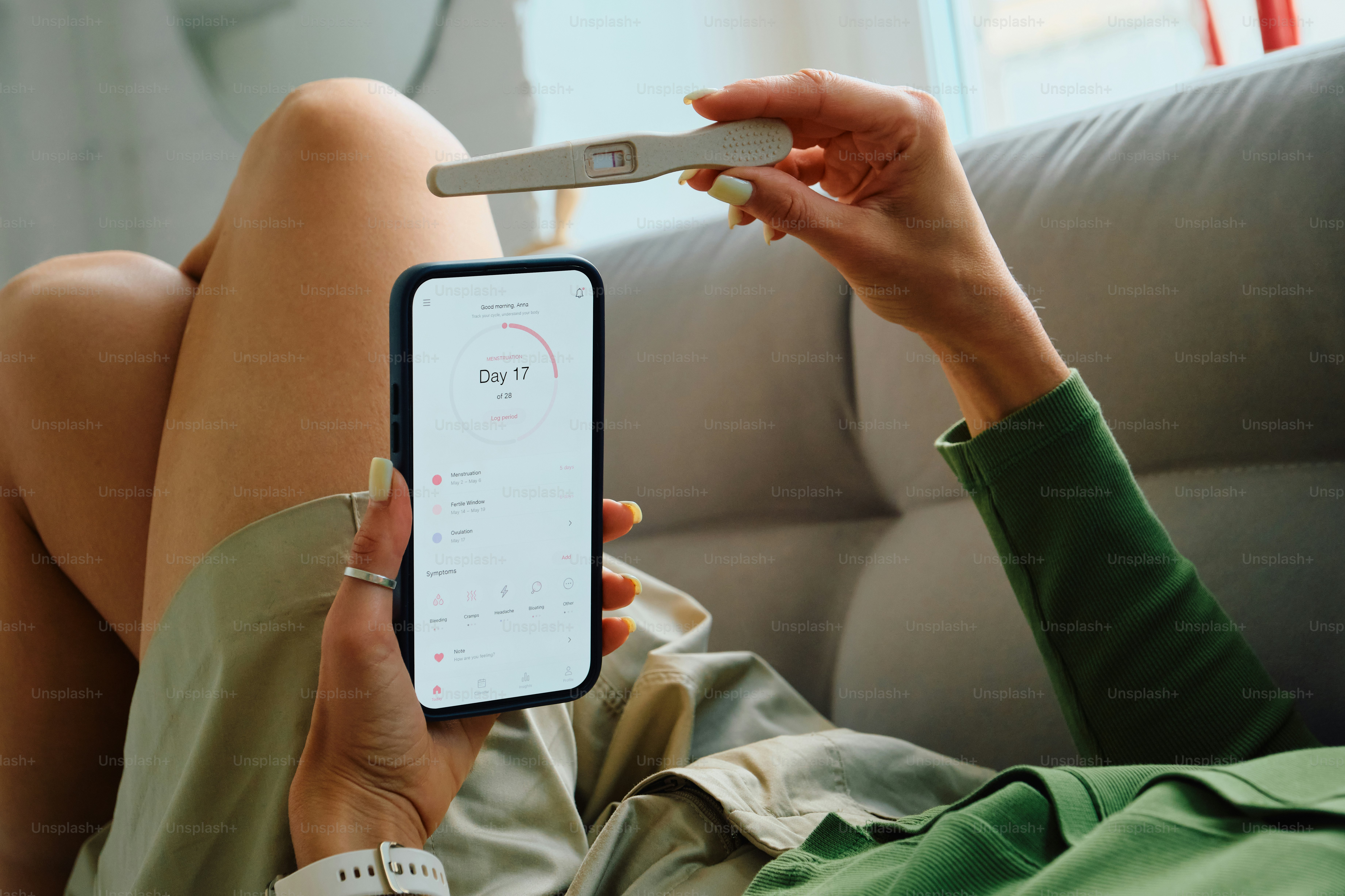 La femme tient un test de grossesse et un téléphone avec l’application santé.