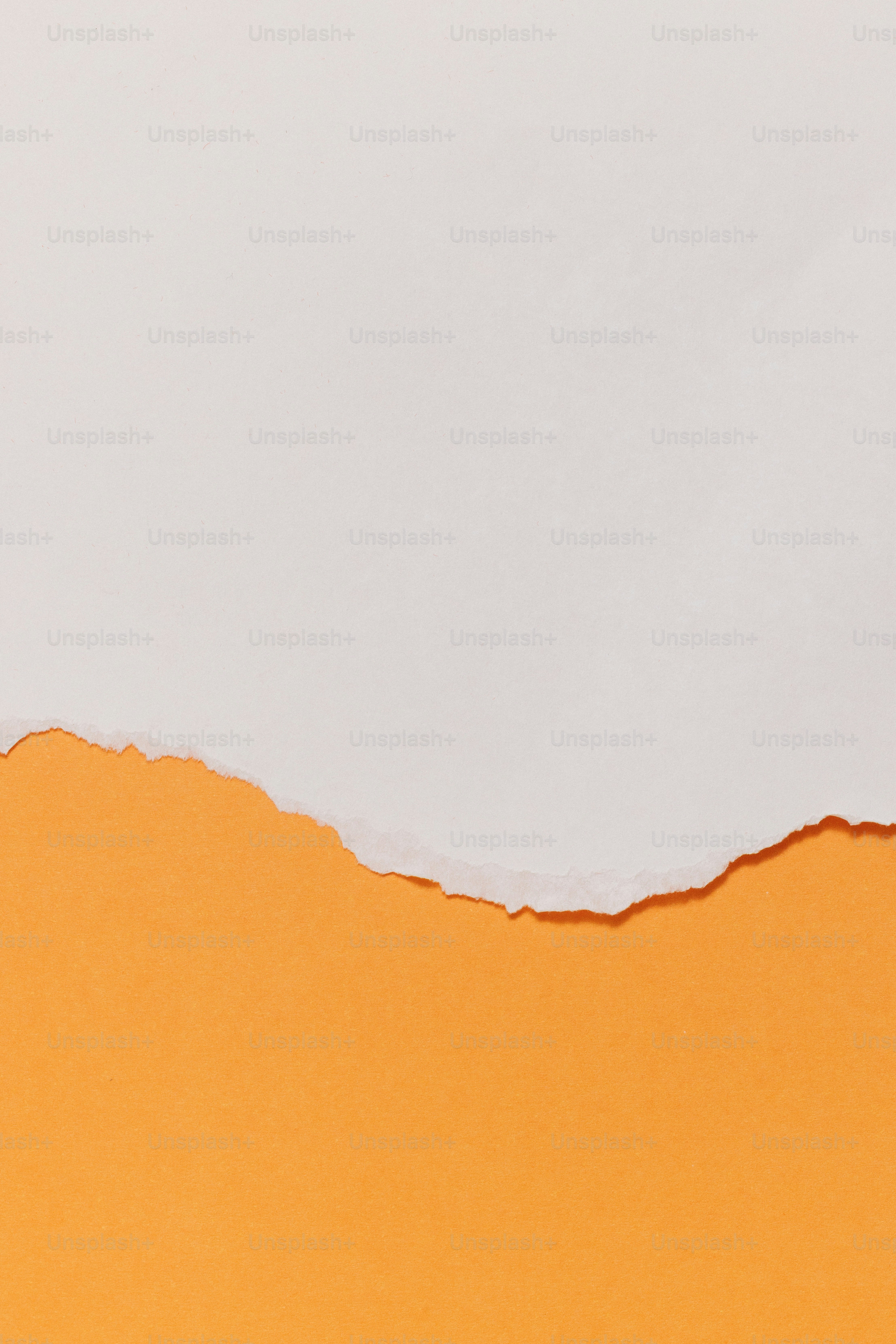 Torn white paper revealing an orange background.