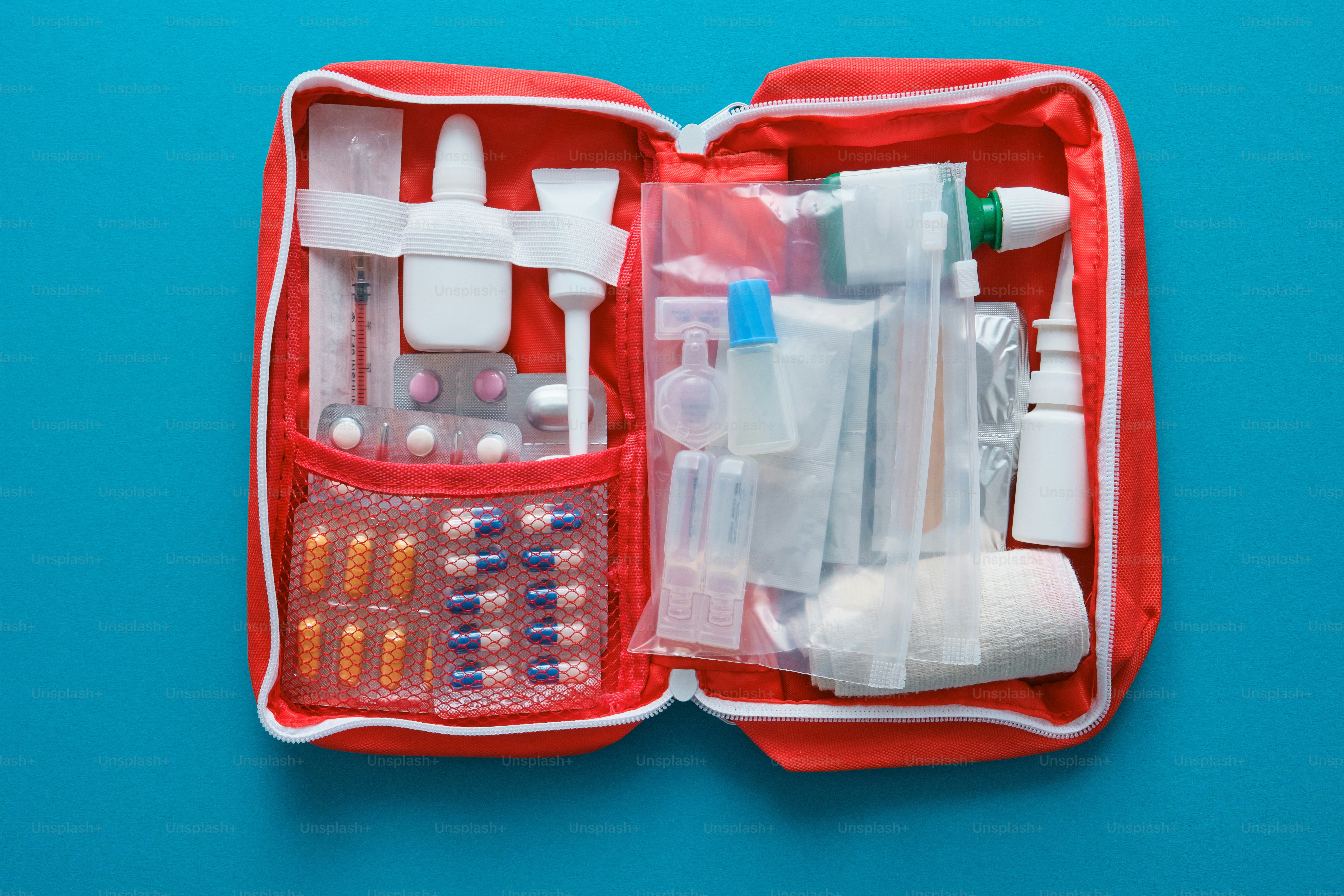 A translucent first-aid kit with a white cross on blue. photo ...