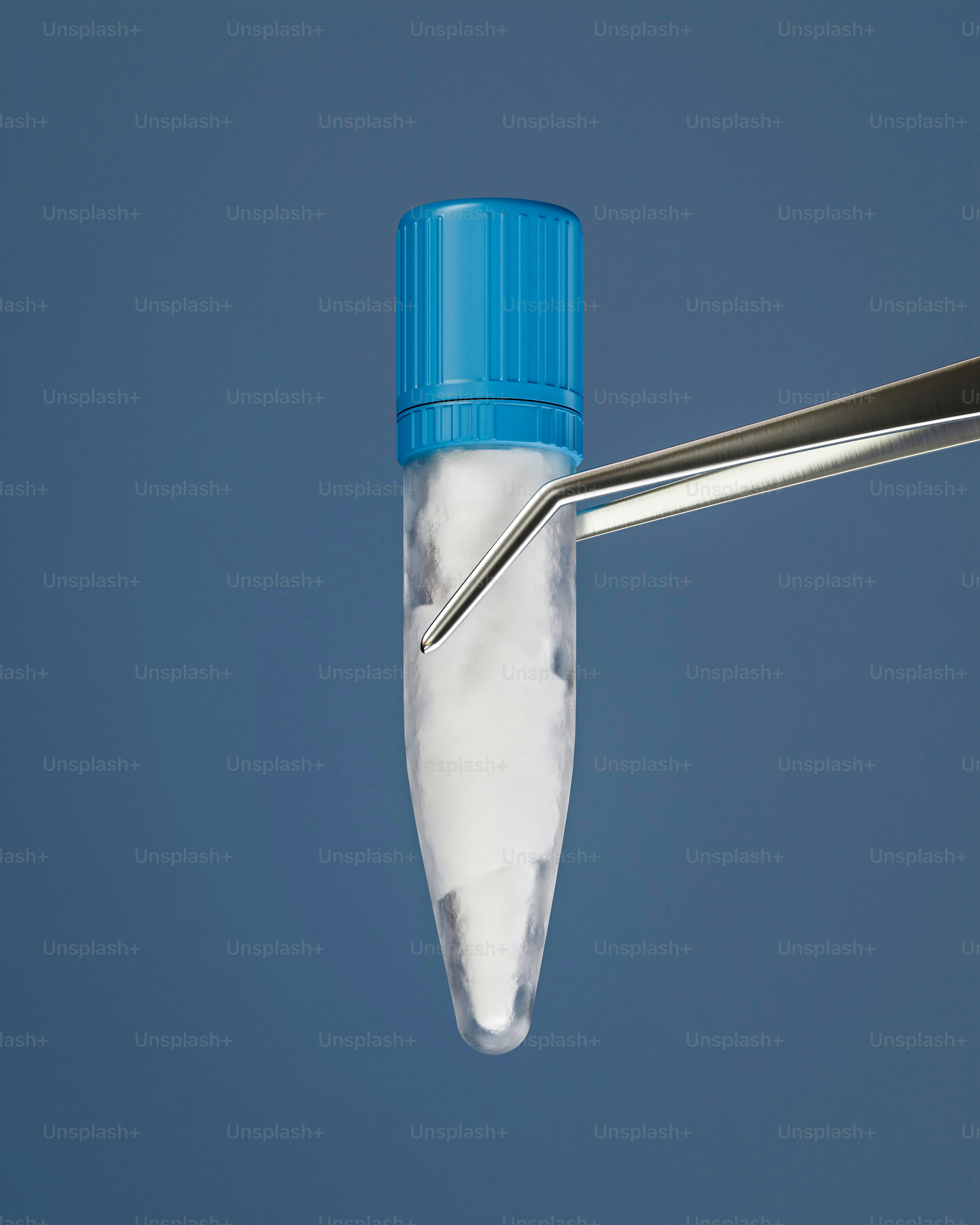 Tweezers holding a clear vial of white powder.