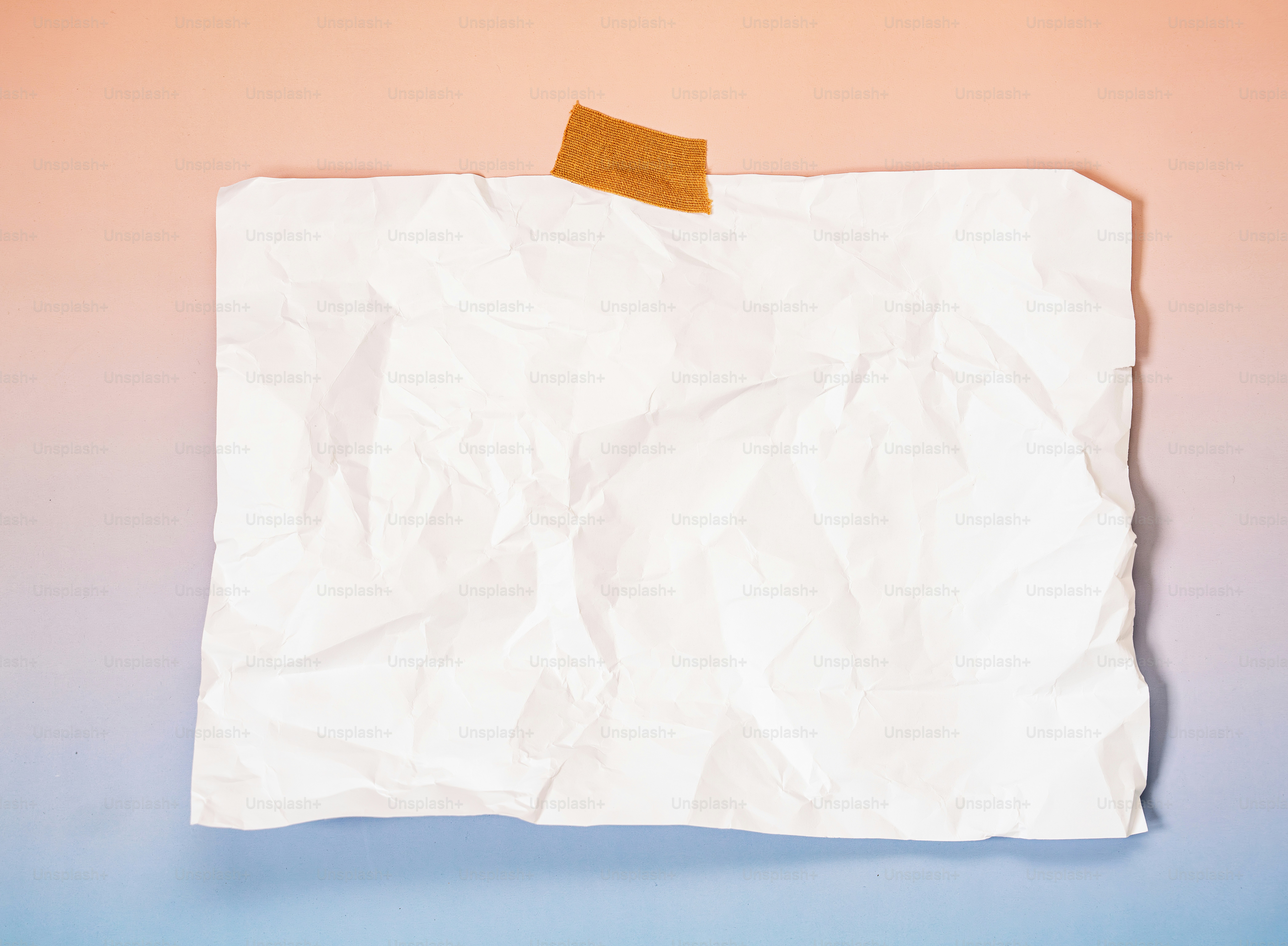 Un mot en papier blanc froissé collé sur un fond dégradé.
