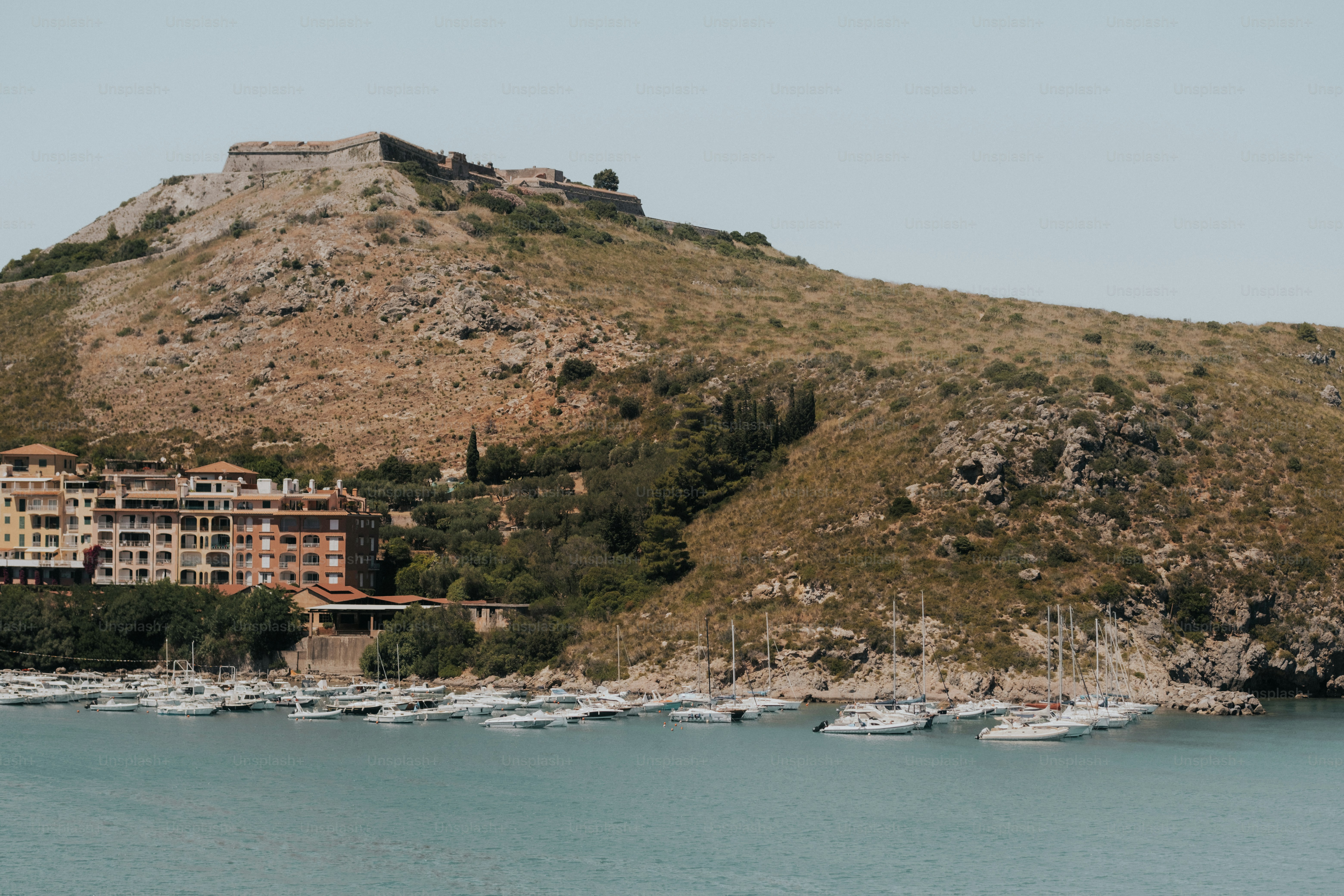 Hilltop fortress overlooking coastal town and marina