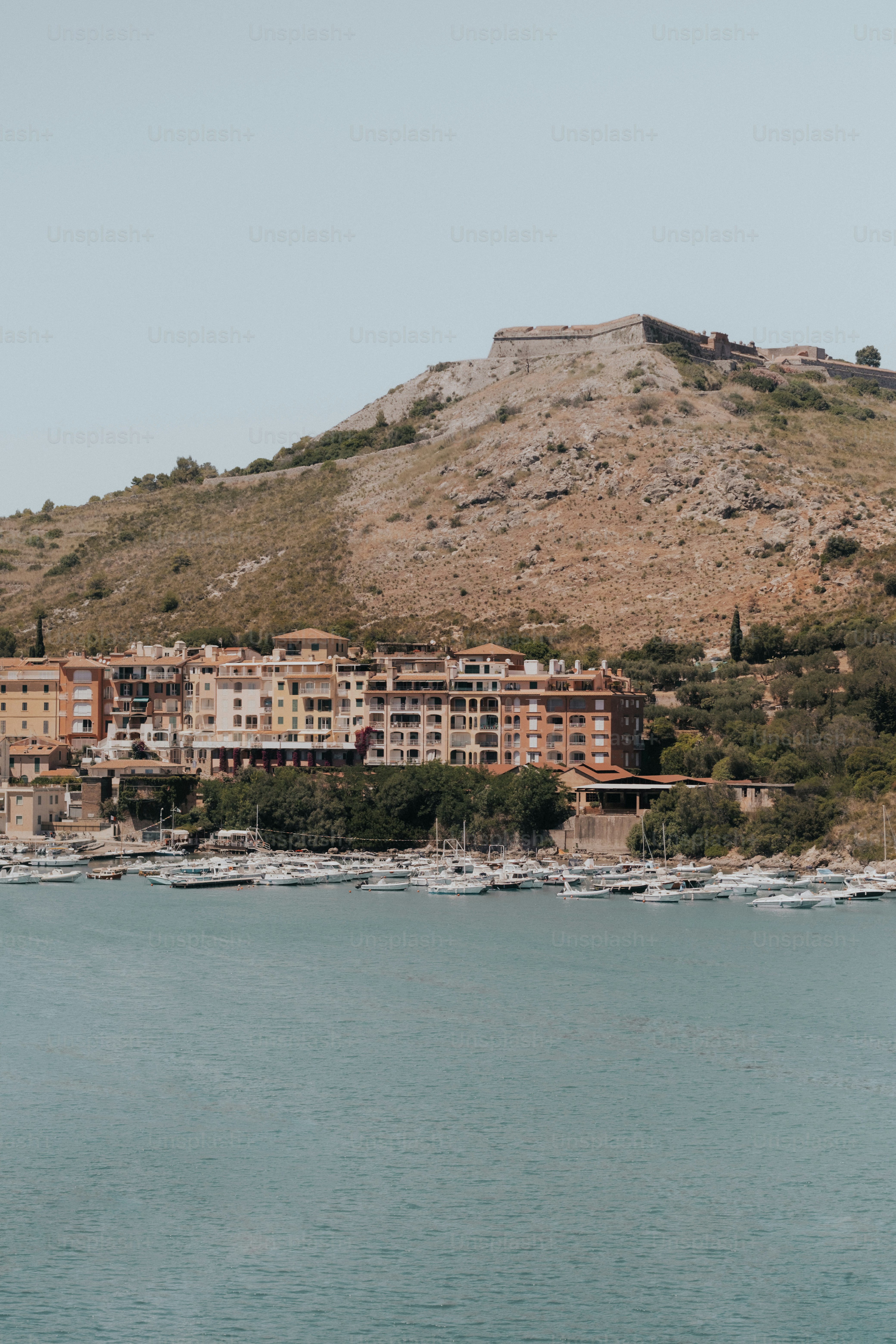 Town and marina beneath fortress on rocky hill