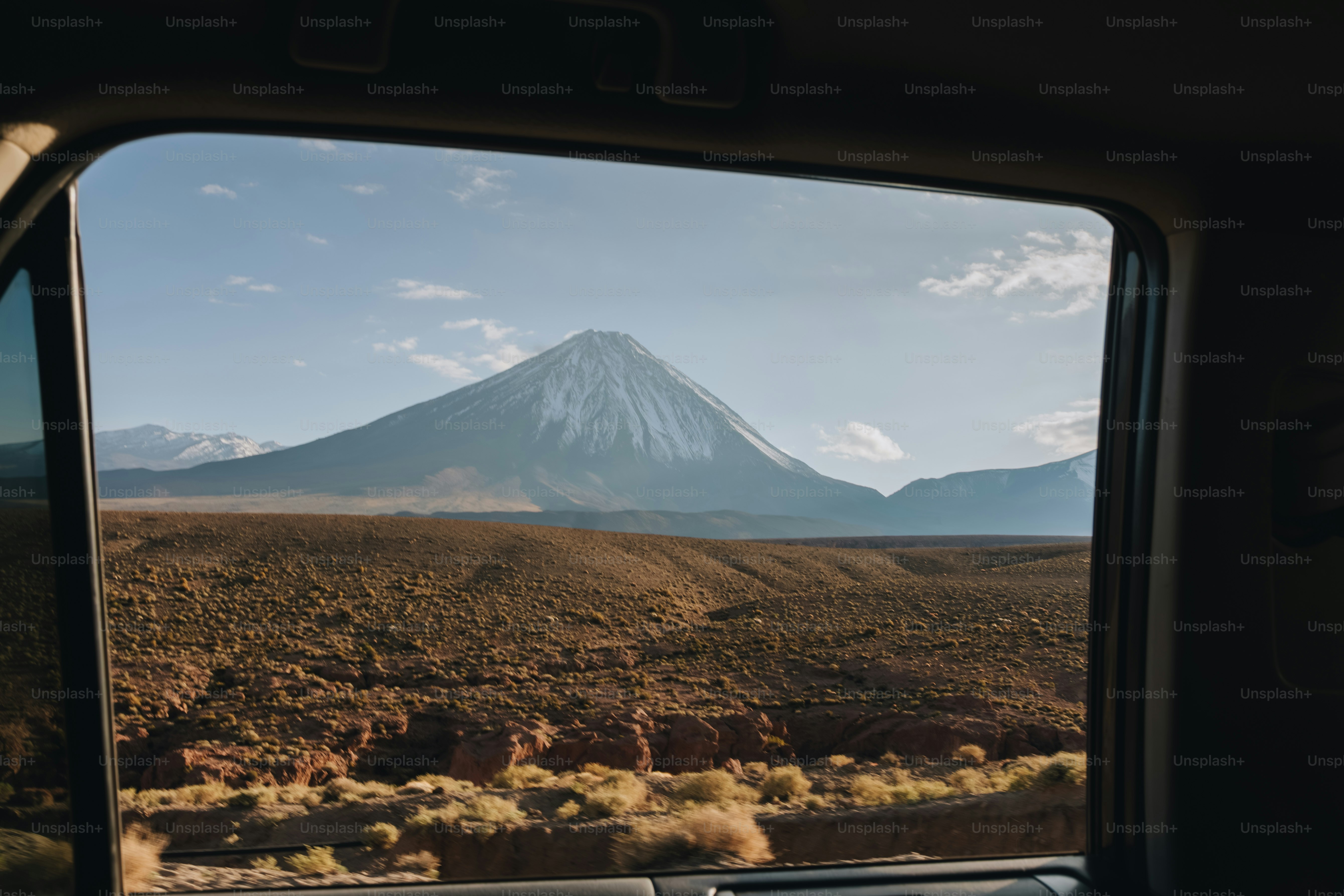 View of a snow-capped mountain from a car window