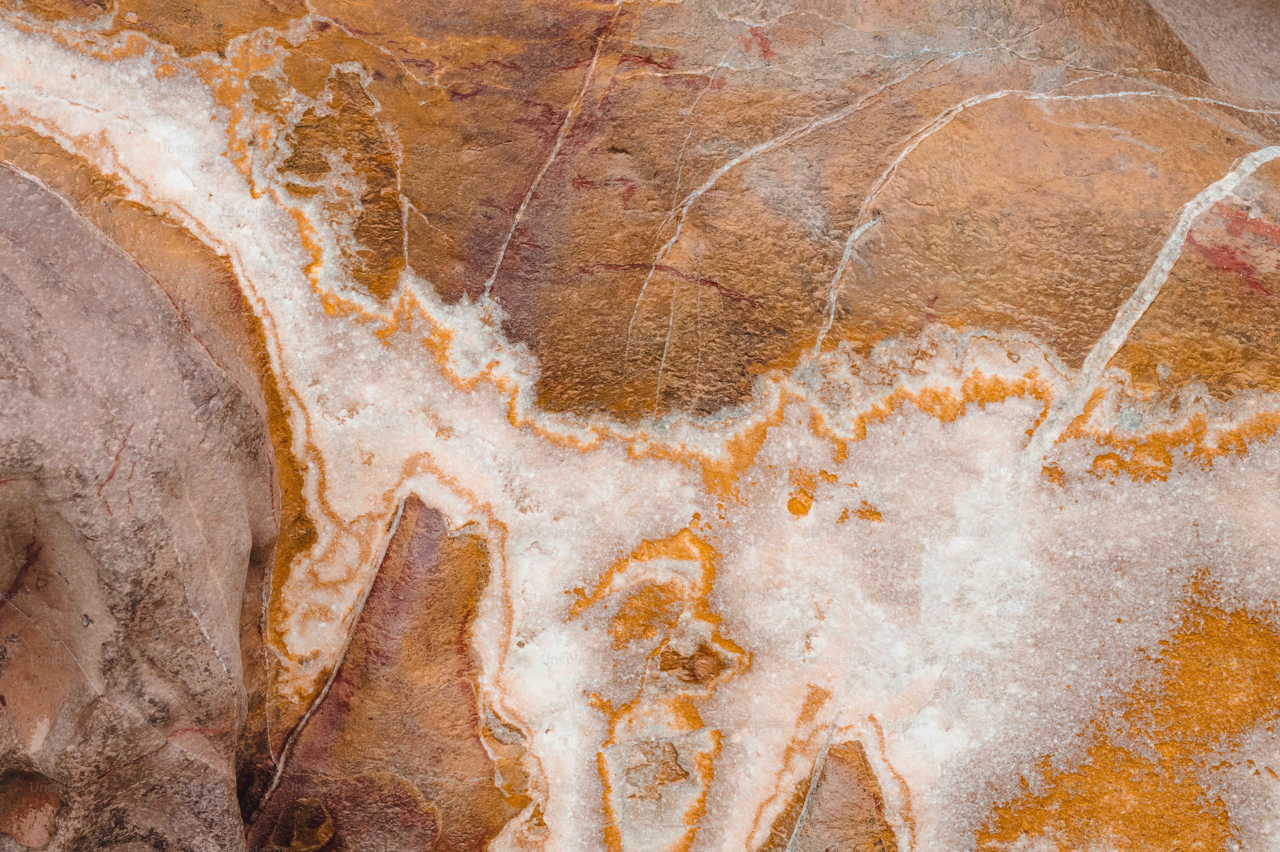 Abstract brown, orange, and white marble stone texture background.