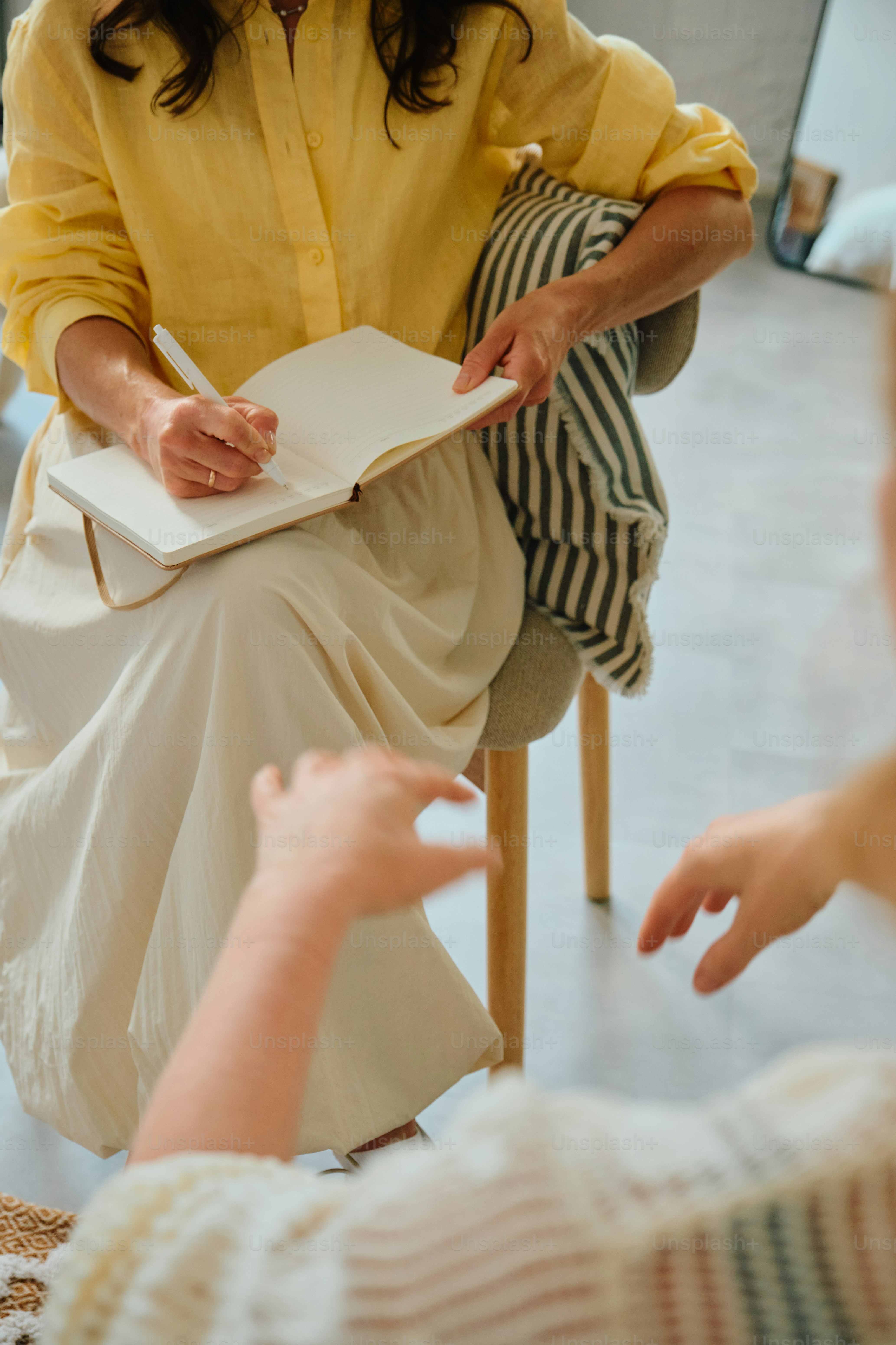 Counseling session with therapist taking notes
