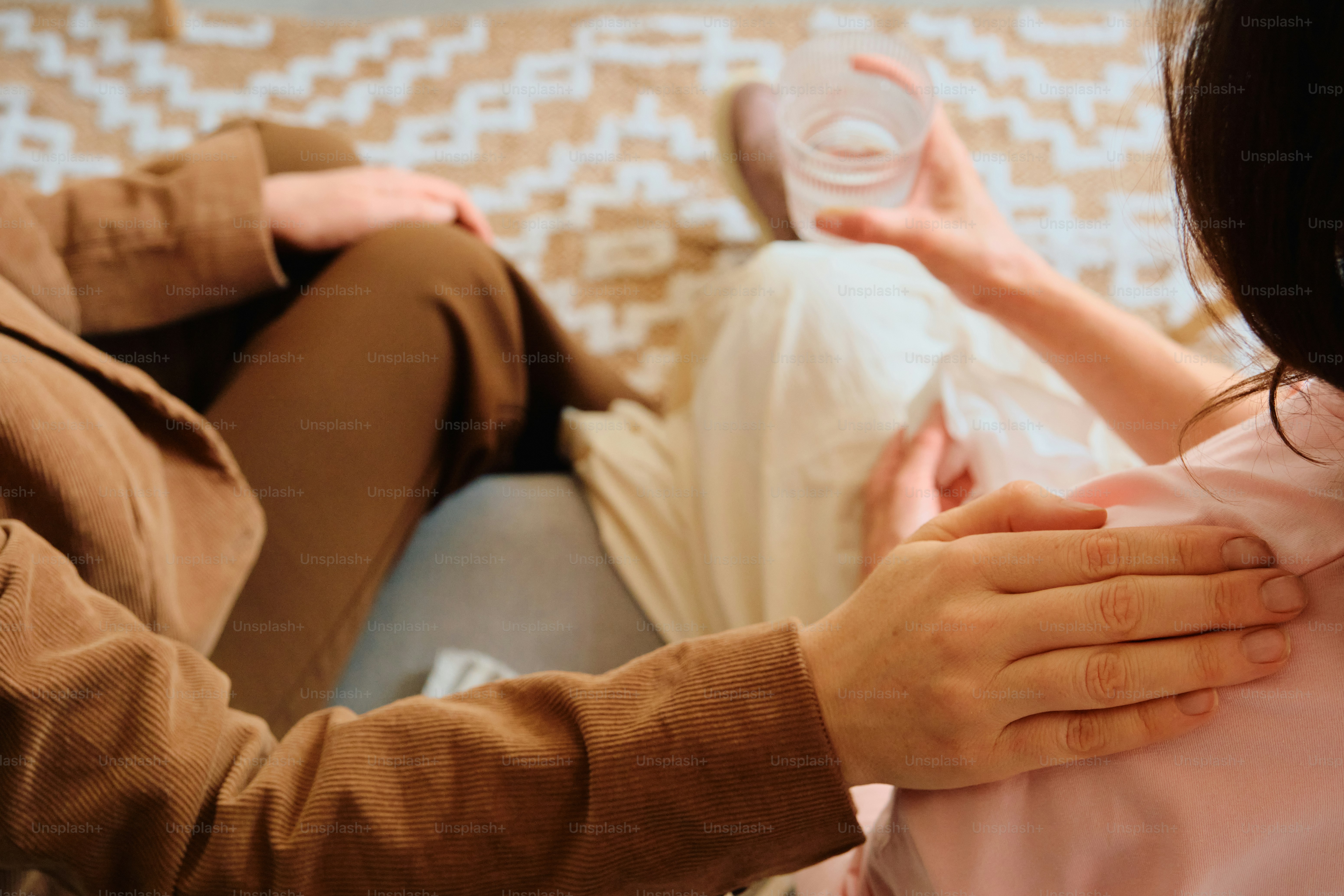 Supportive hand on shoulder in therapy session
