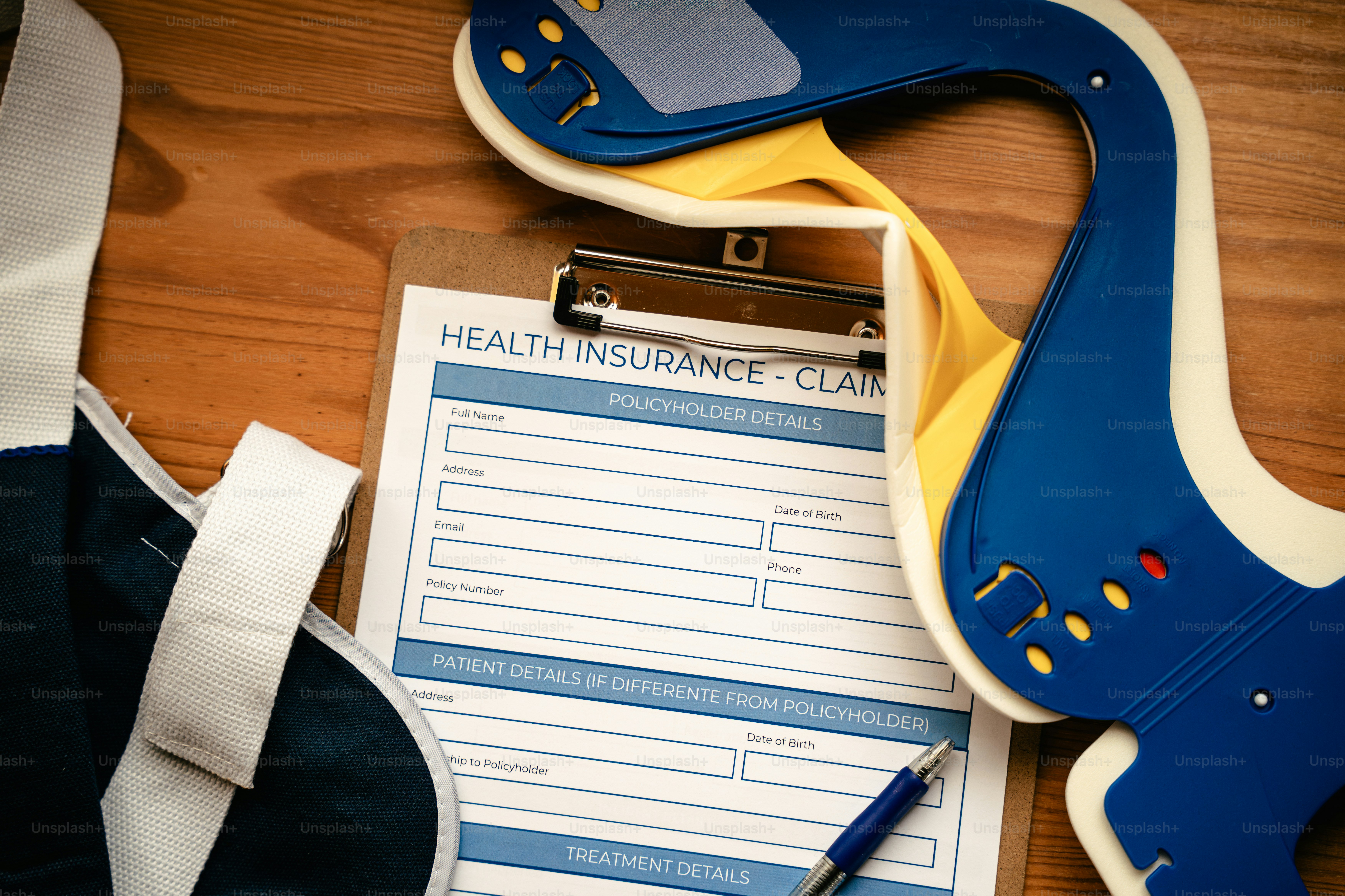 Health insurance claim form with neck brace and pen