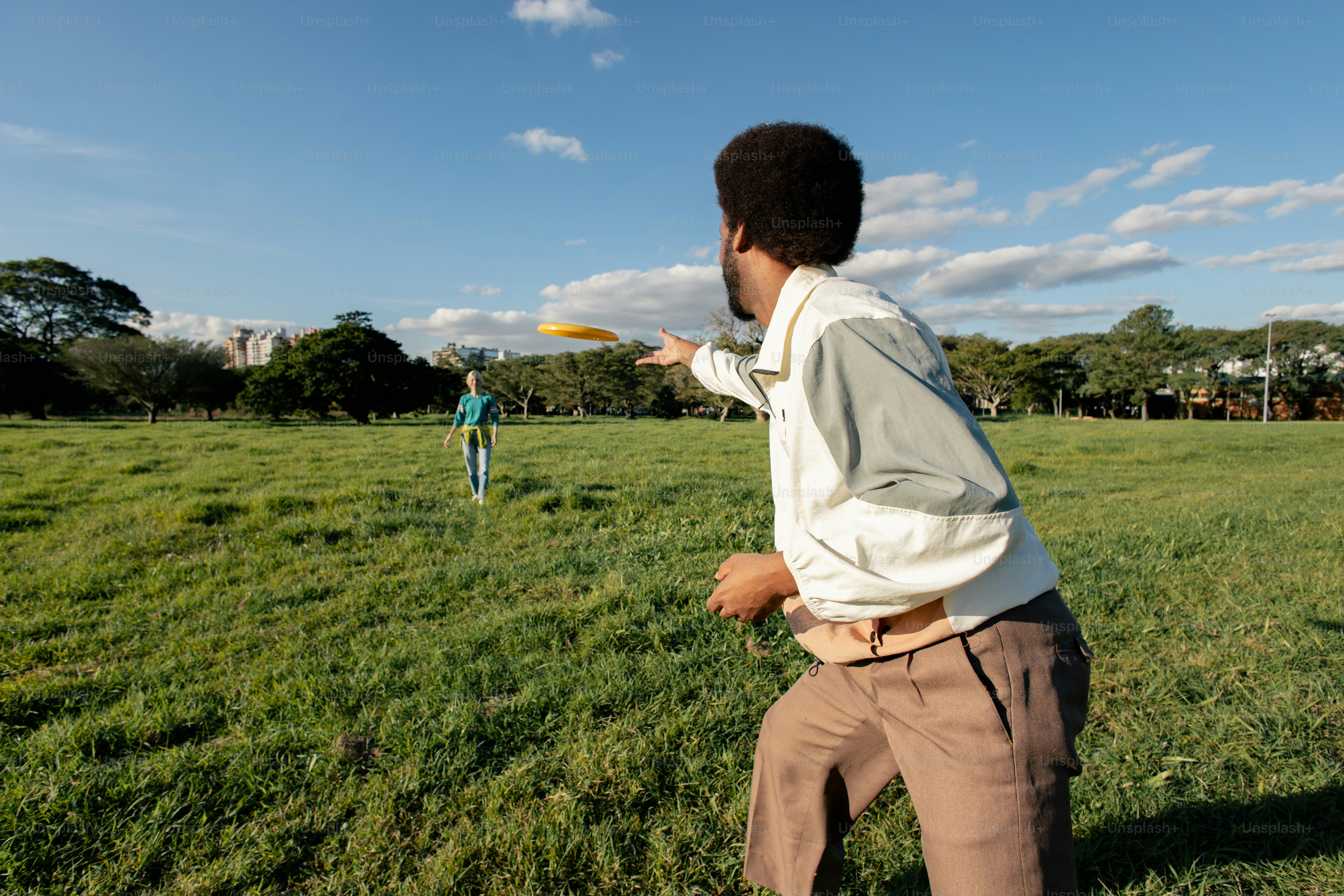 Person throwing a frisbee in a grassy field
