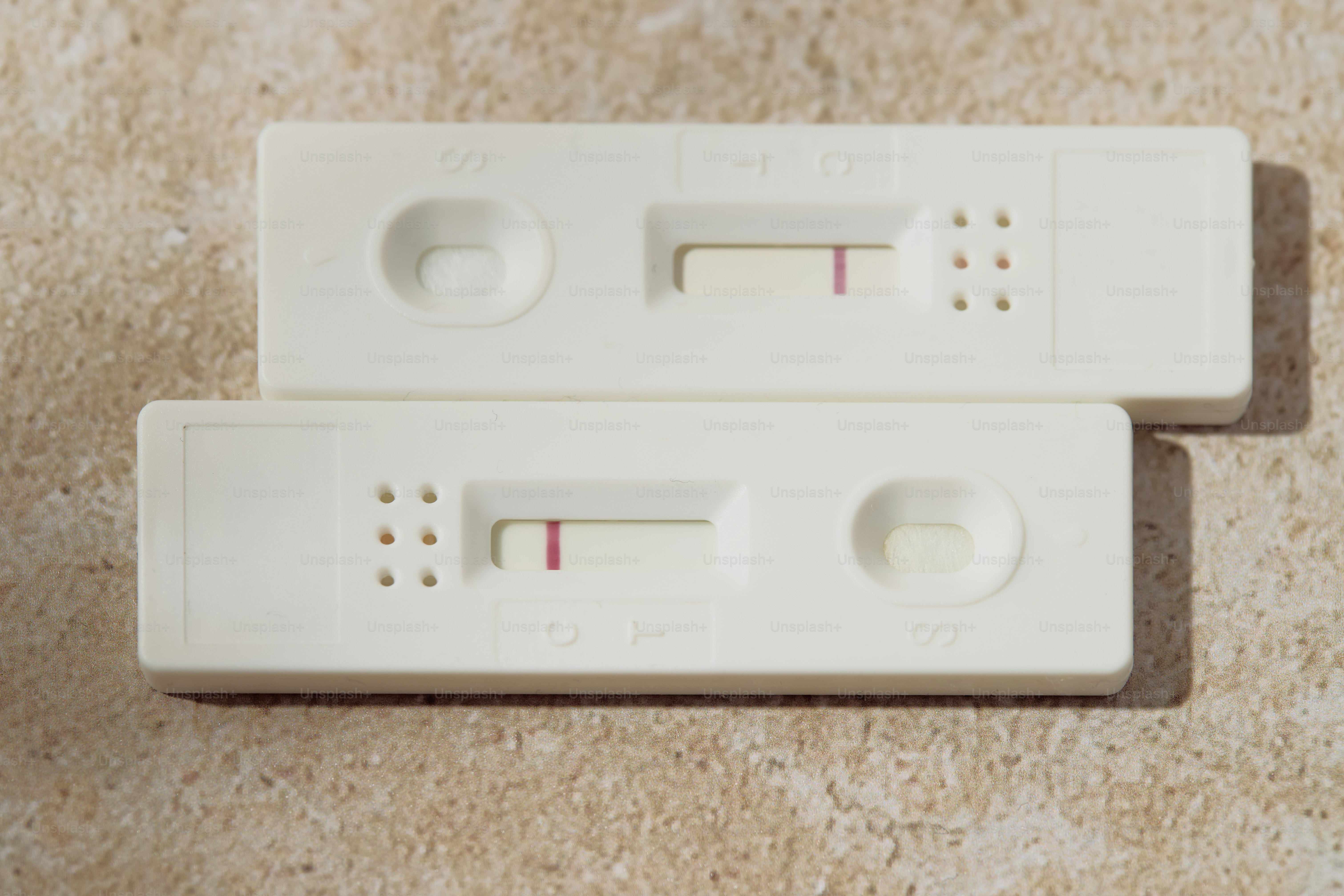 Two pregnancy tests displaying single pink lines photo – Health Image ...