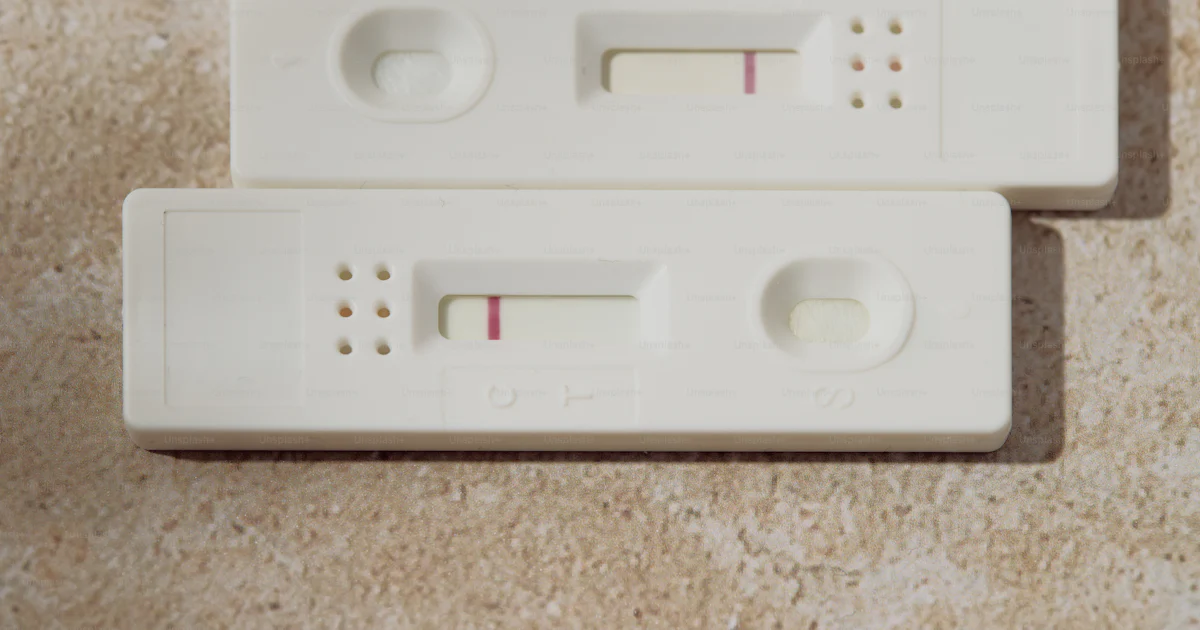 Two pregnancy tests displaying single pink lines photo – Health Image ...