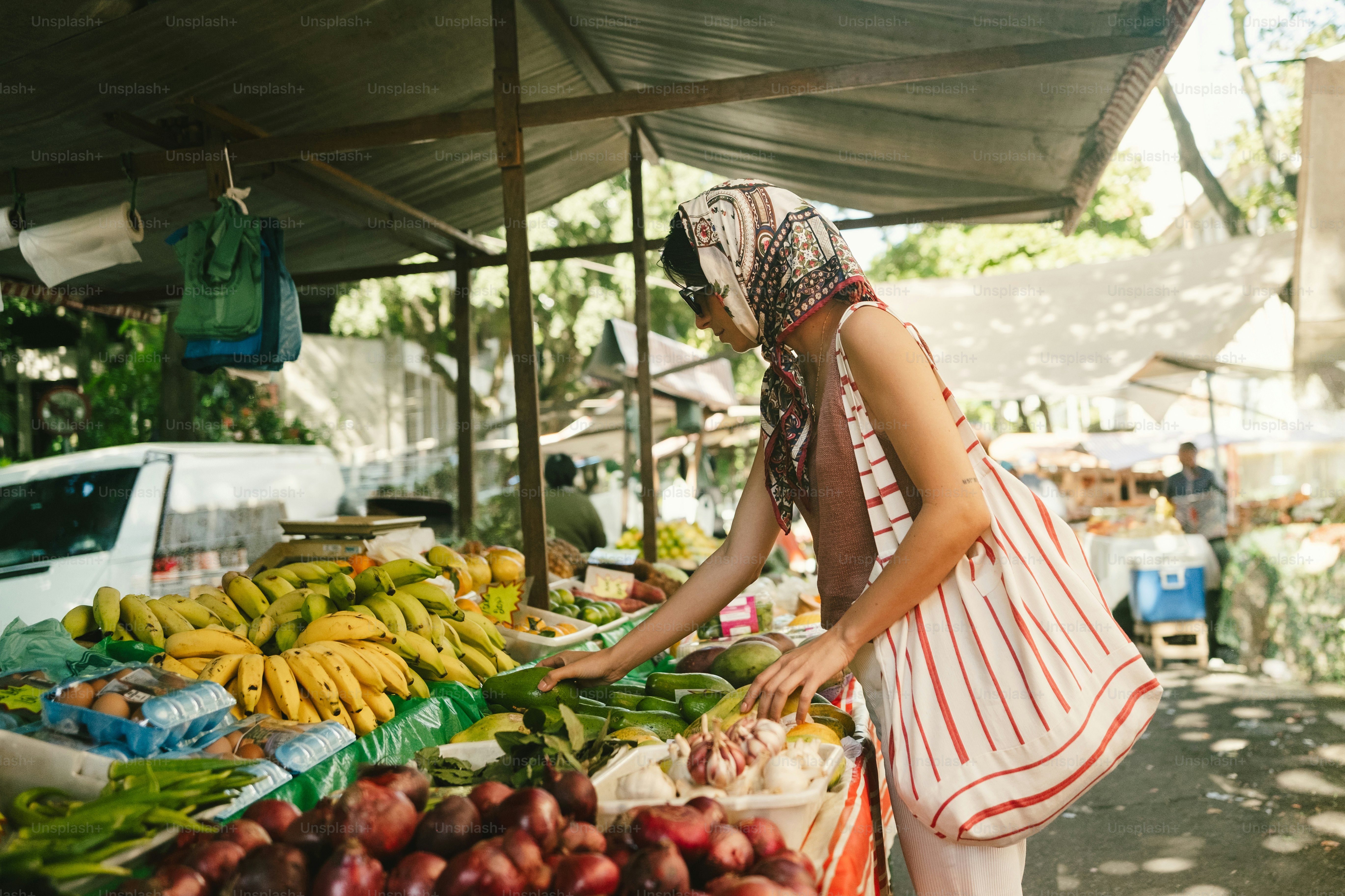 Woman selecting fresh produce at outdoor market