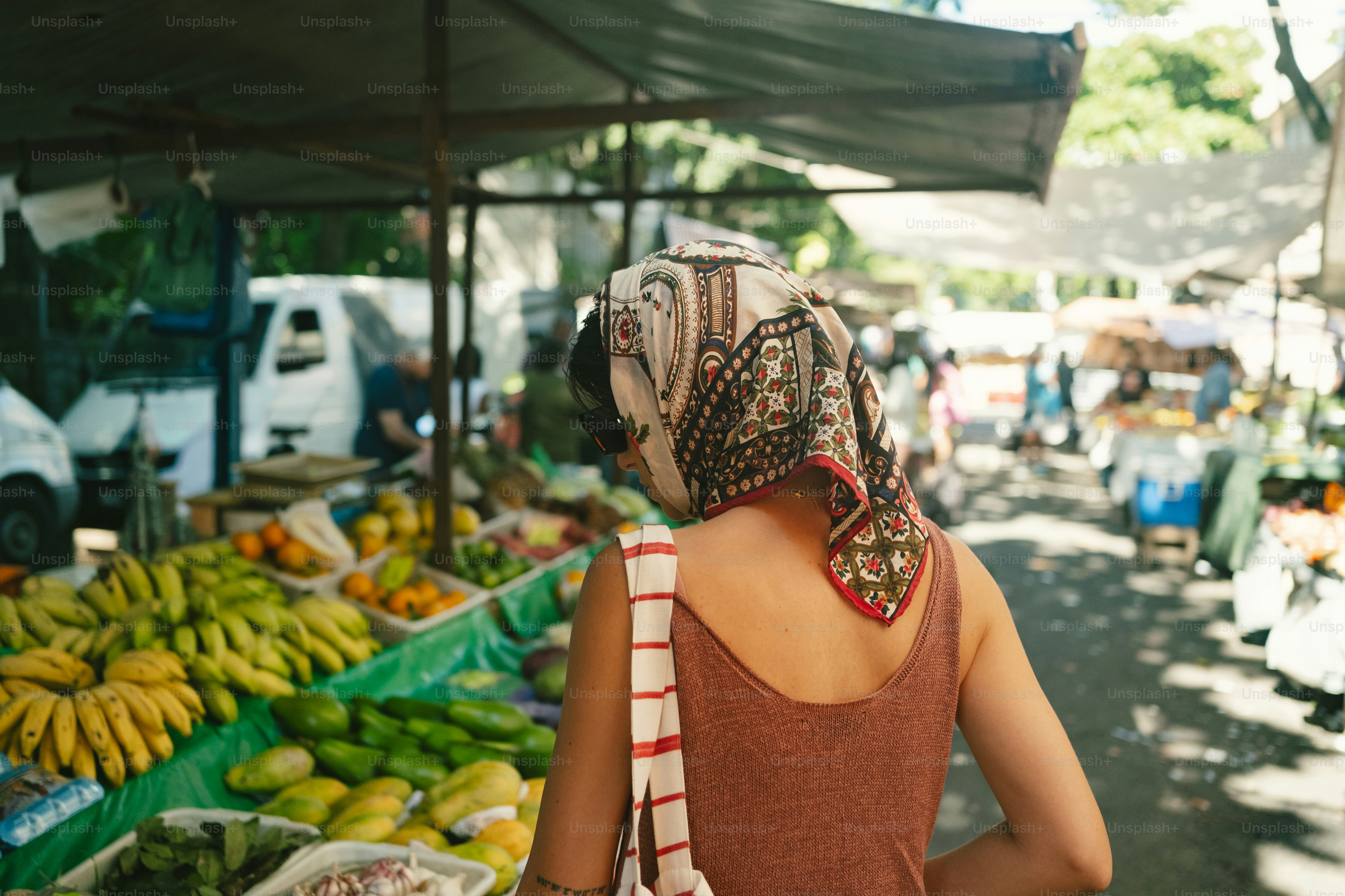 Woman with headscarf at bustling outdoor market
