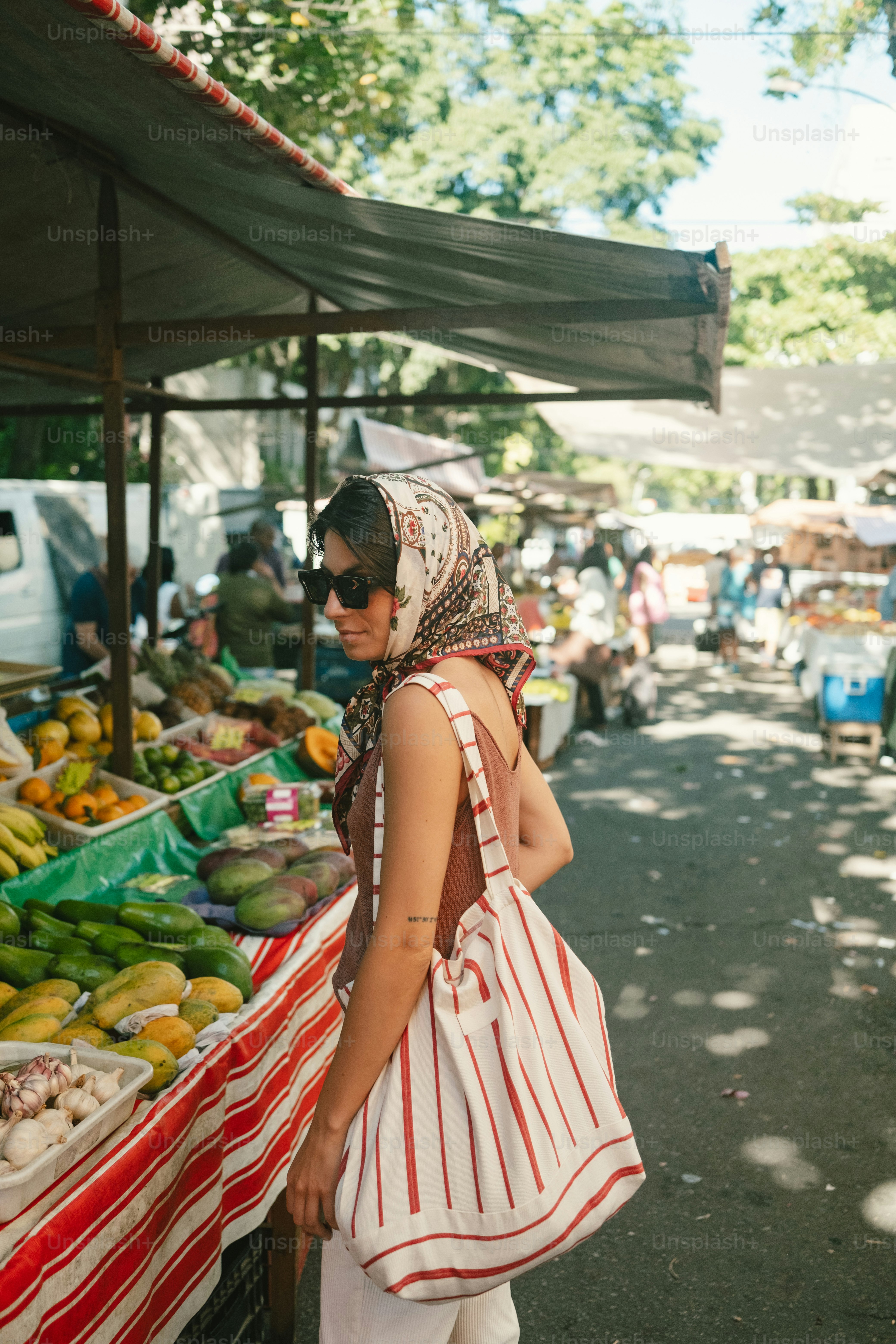 Woman with headscarf shopping at a fruit market
