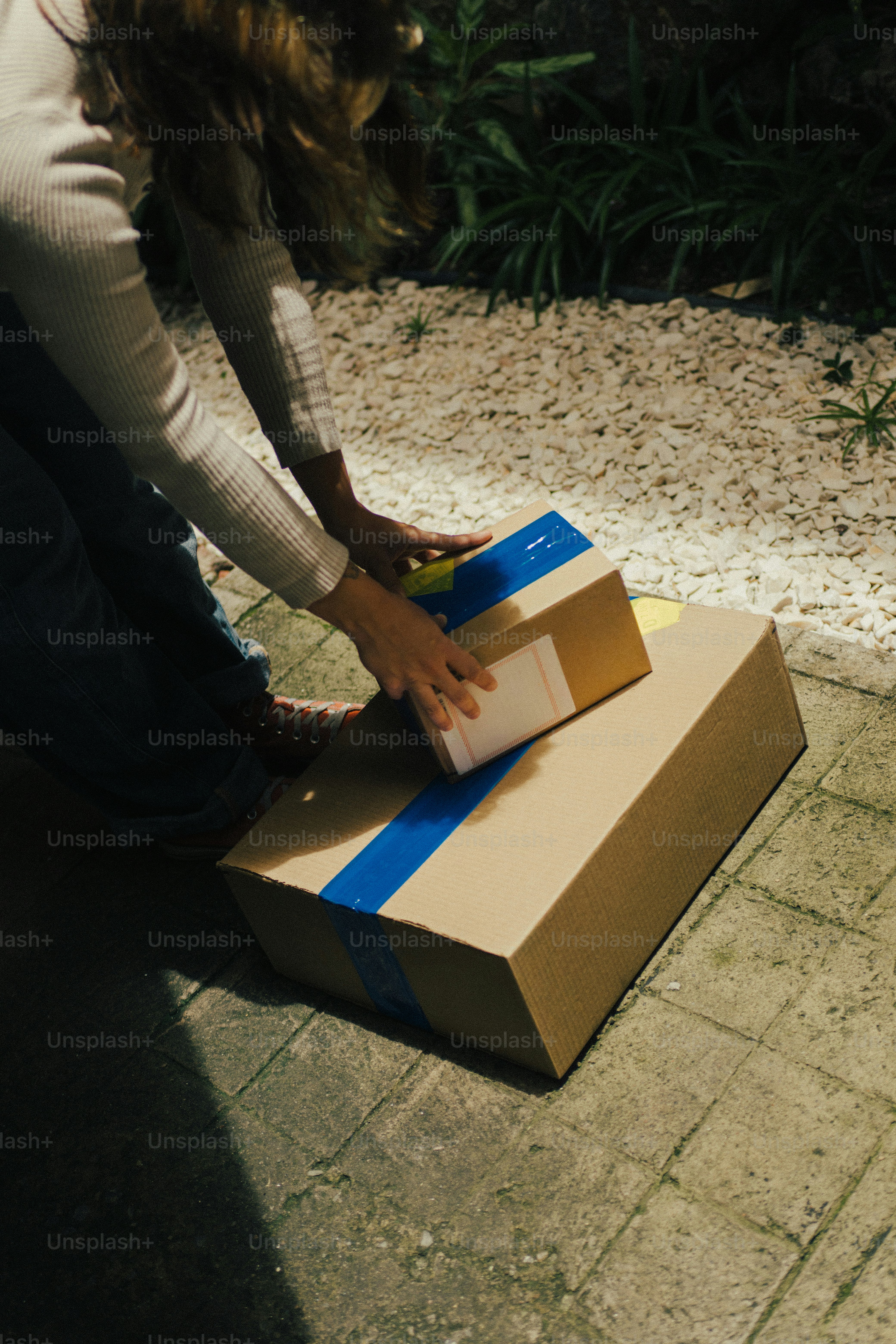 Person placing cardboard parcels carefully in preparation for shipment
