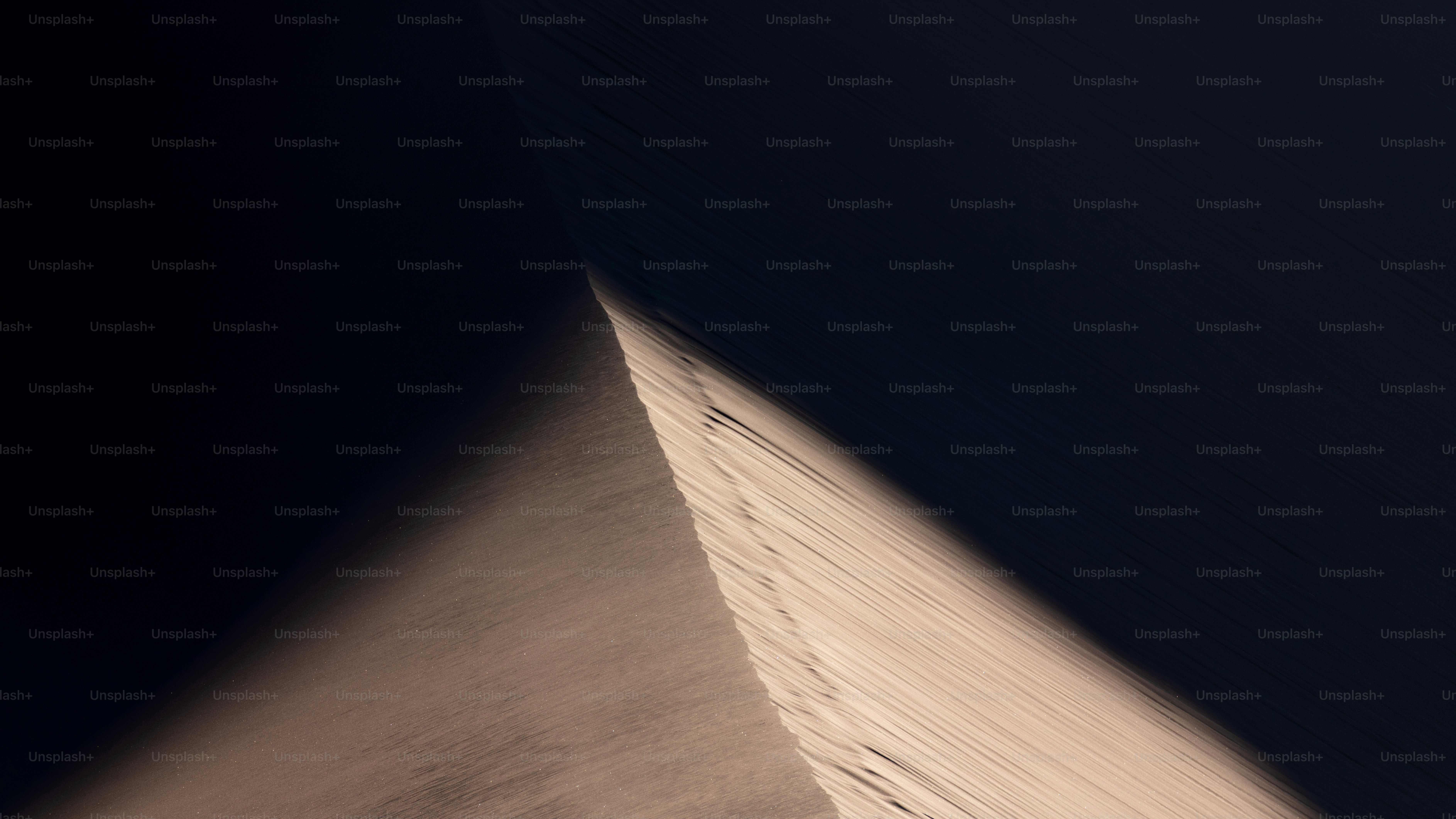 Cresta de dunas arenosas afiladas proyectando una larga sombra