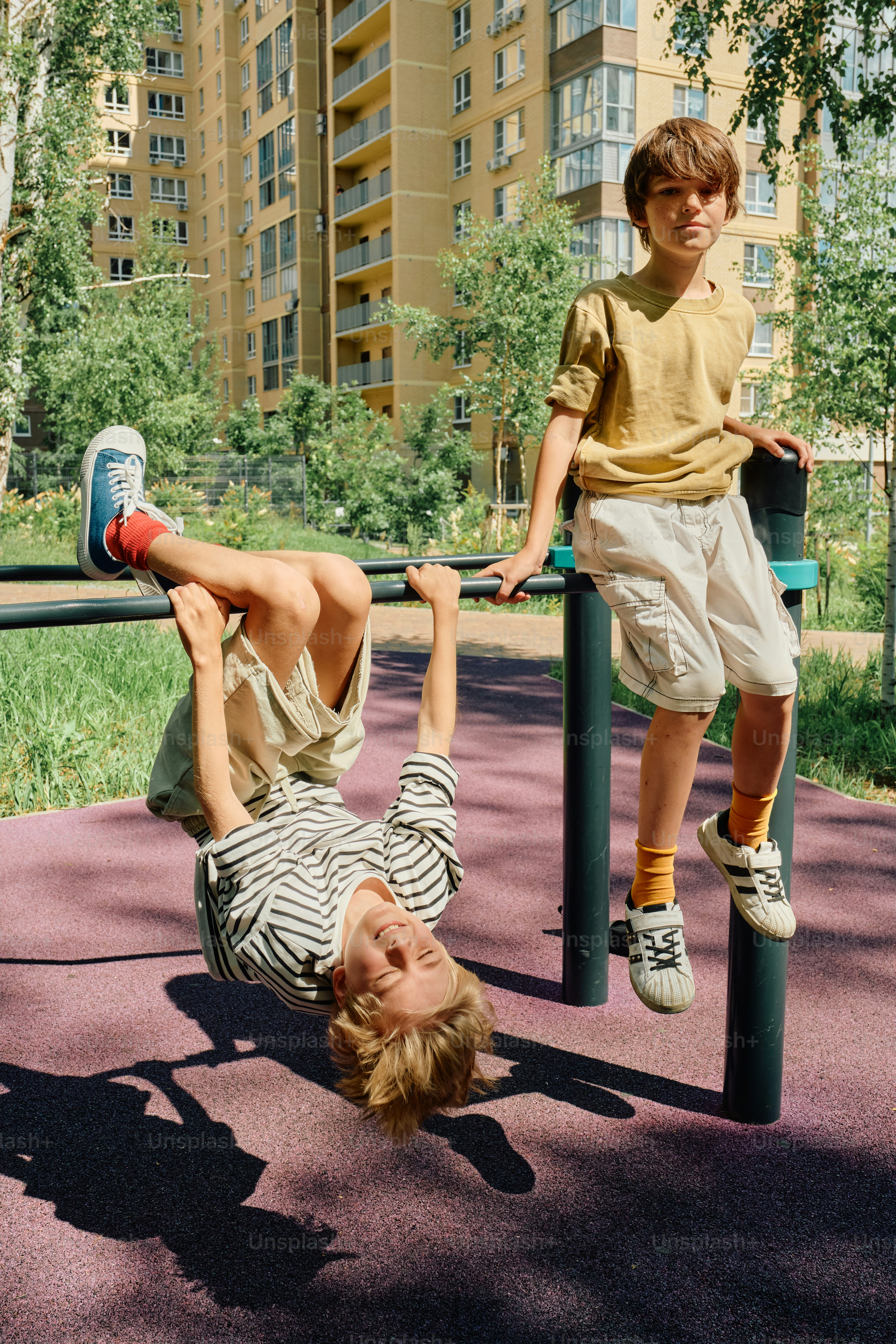 Children playing on playground bars outdoors