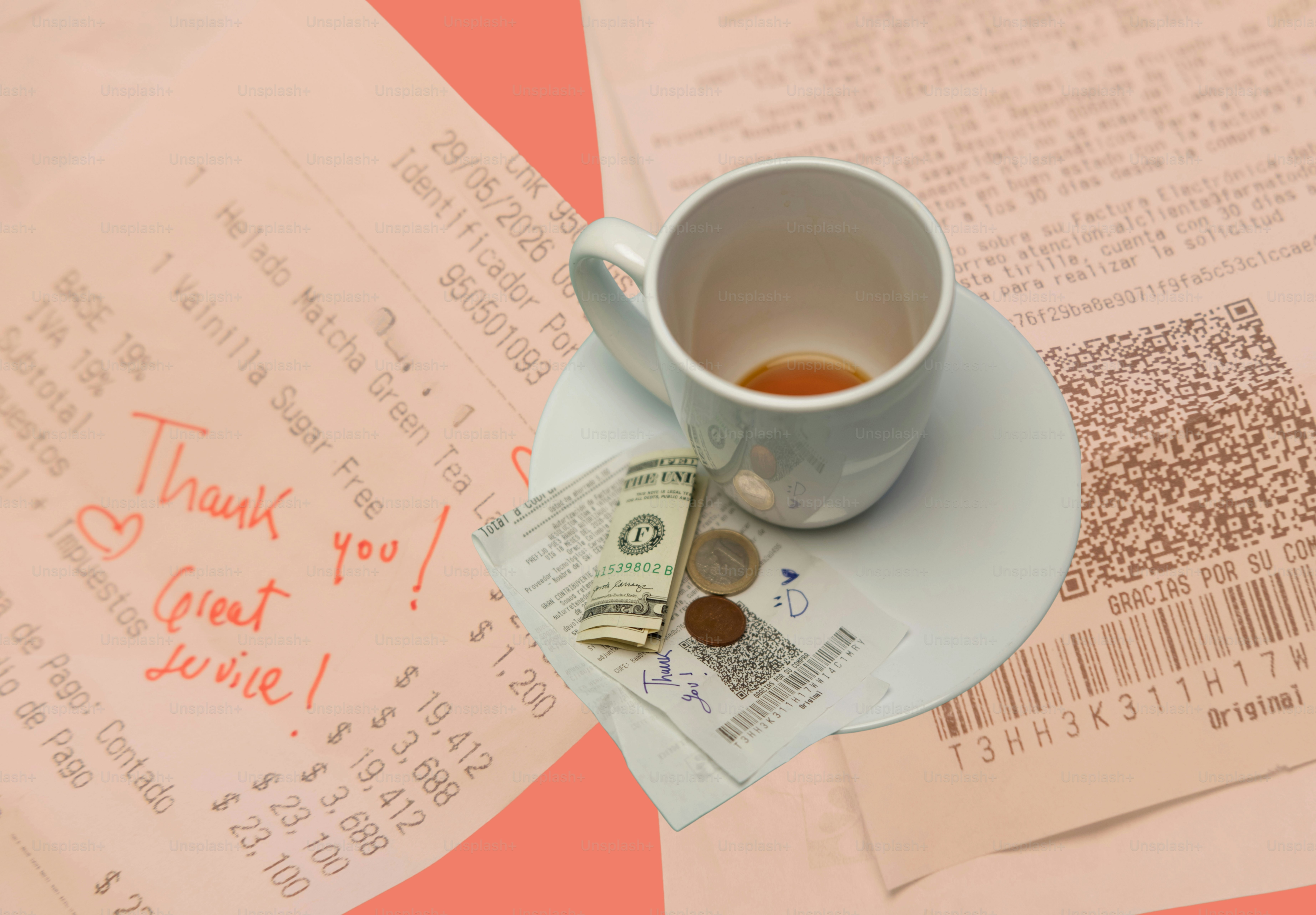 Empty coffee cup, receipts, and cash tip