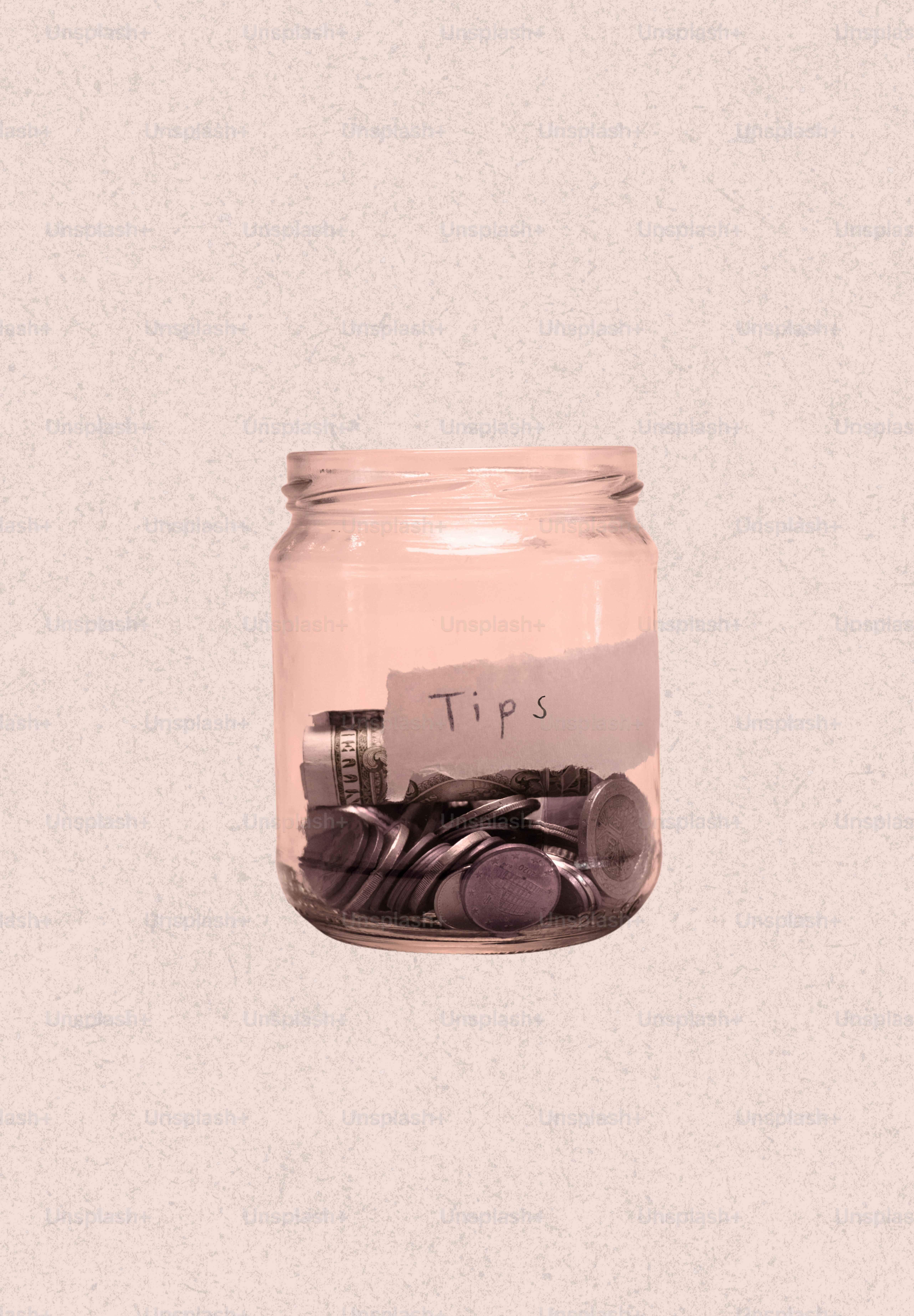 Glass jar filled with coins labeled "tips"