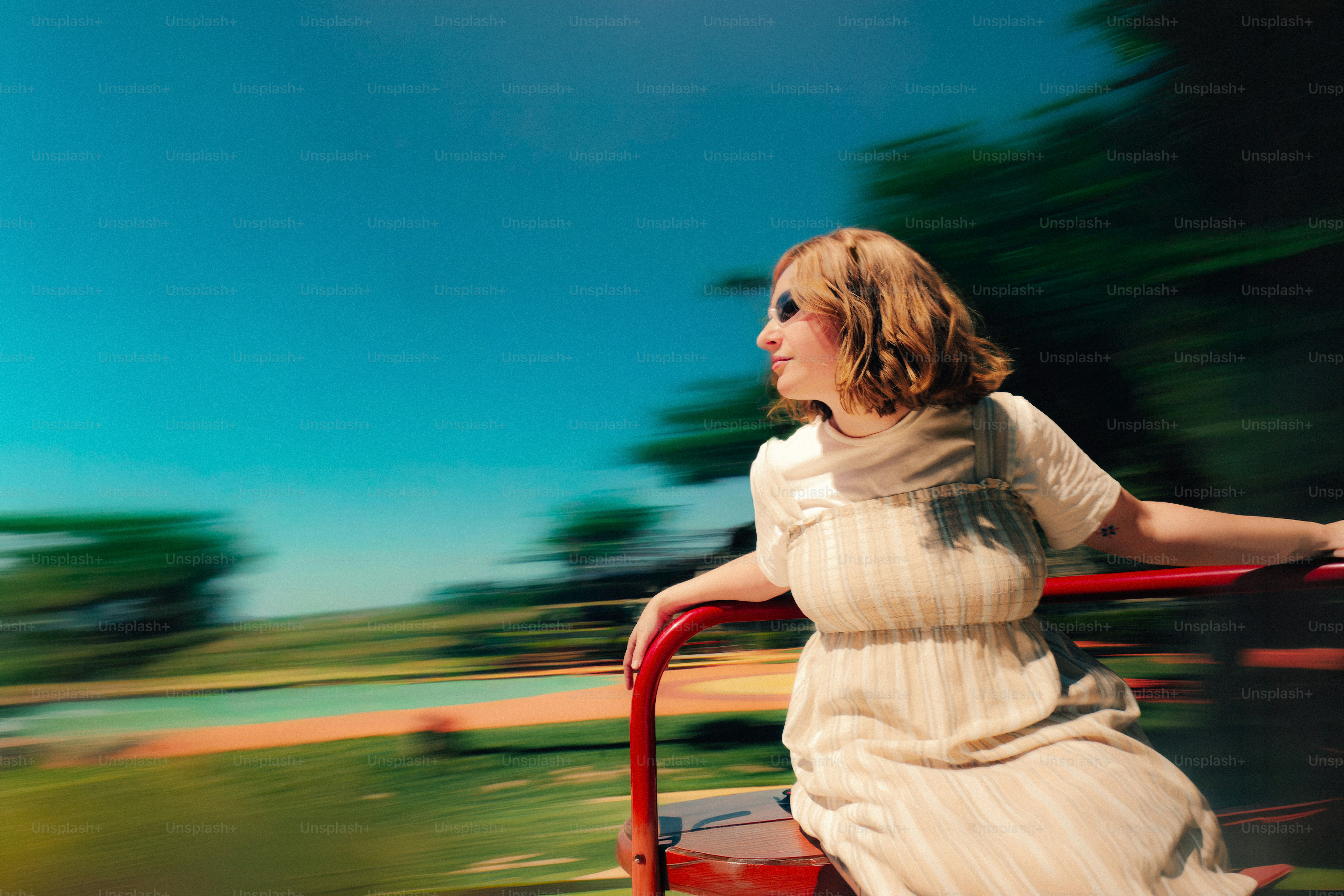 Woman in motion, looking out at blurred landscape