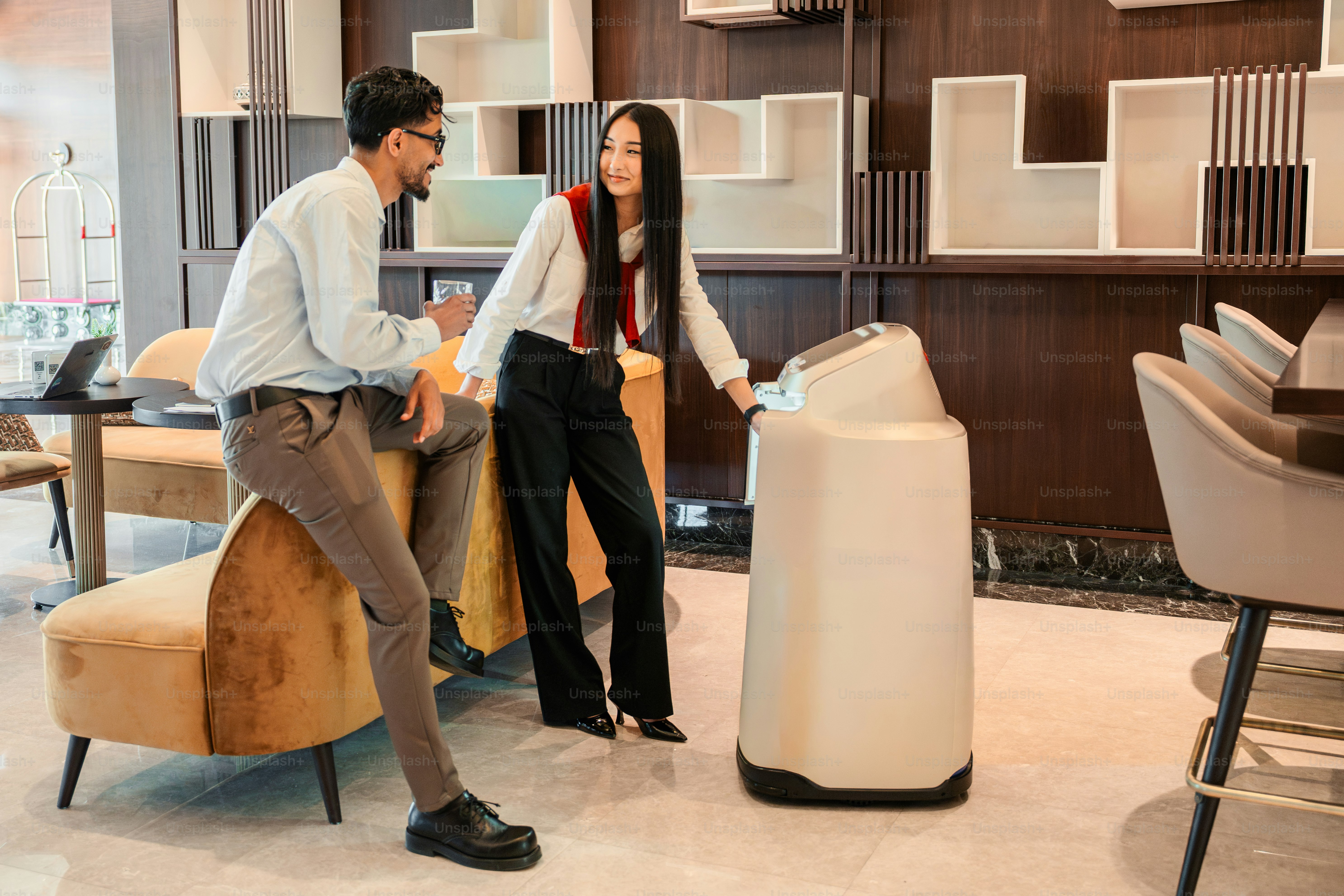 Orang yang berinteraksi dengan robot servis di interior modern