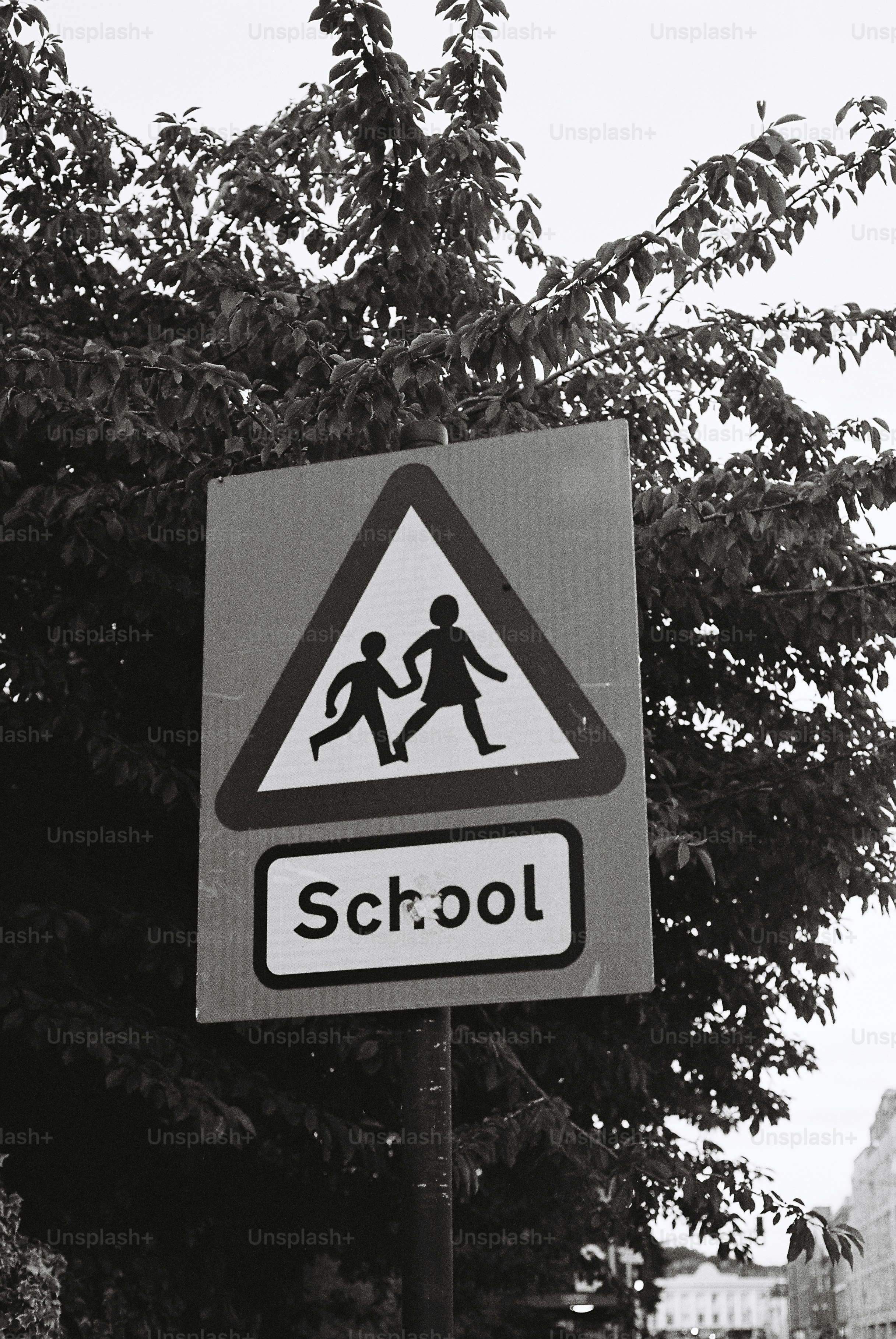 Black and white school sign with children