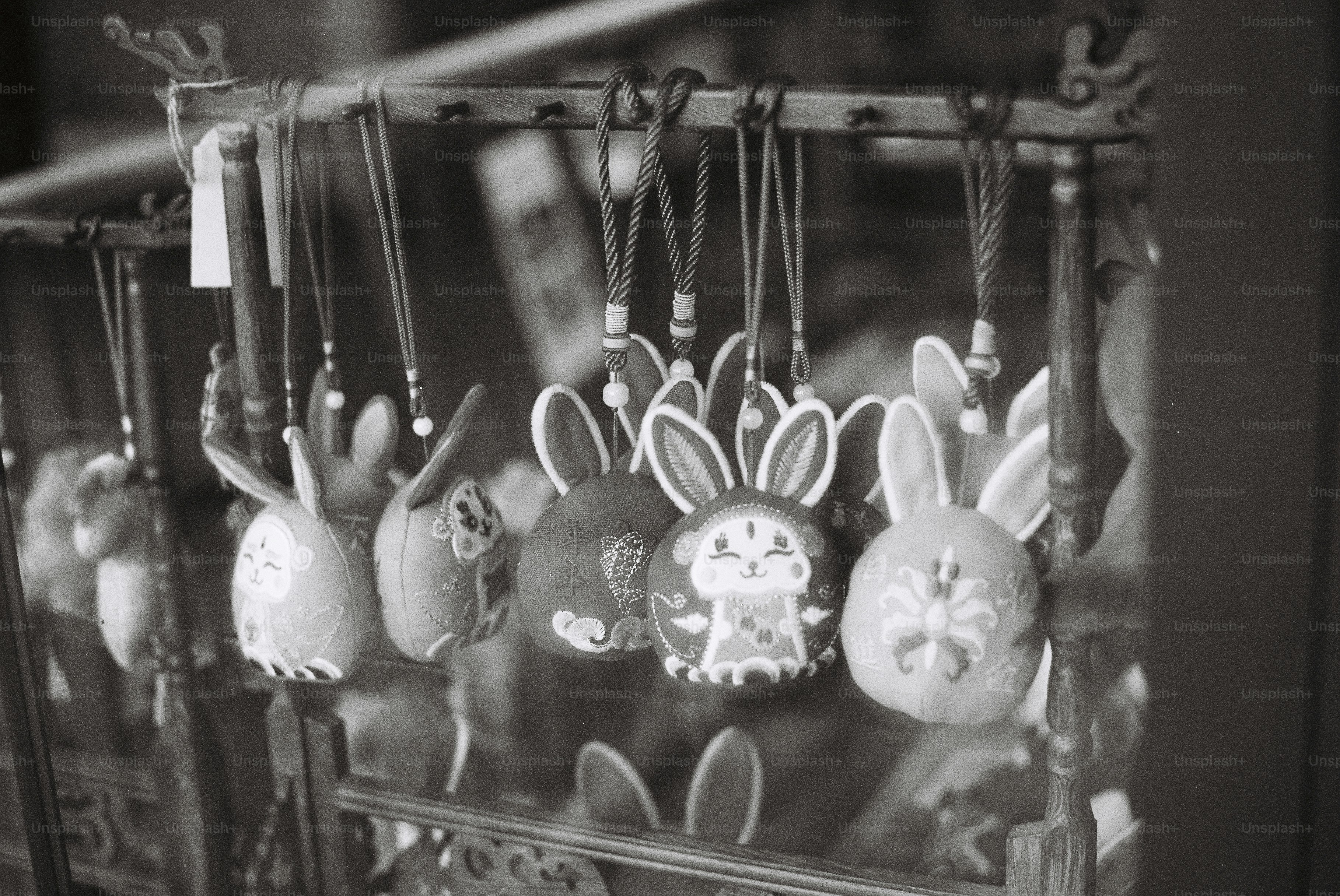 Handmade bunny keychains displayed on a rack
