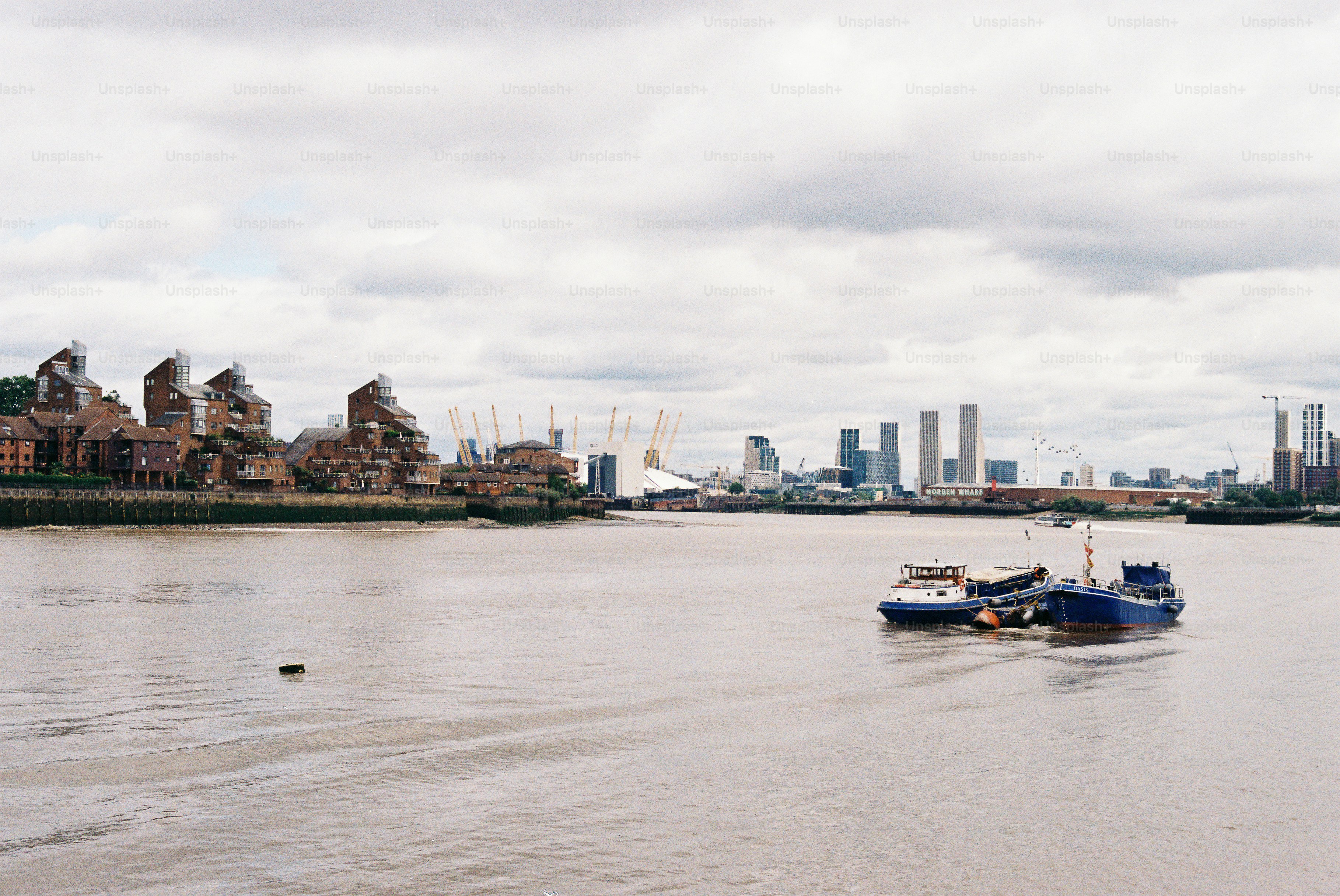 Boats on river with cityscape and o2 arena