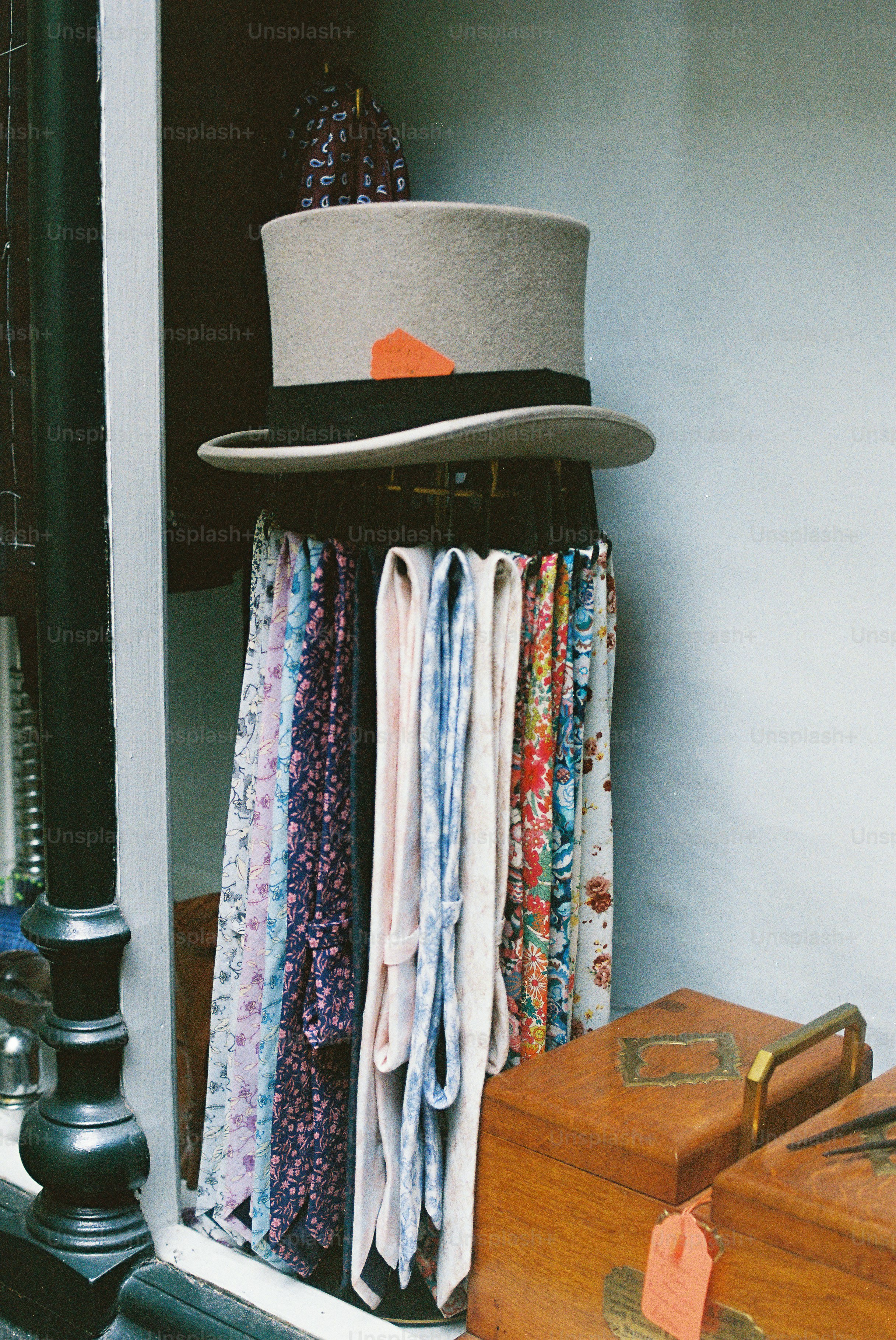 Grey top hat and patterned ties displayed in shop