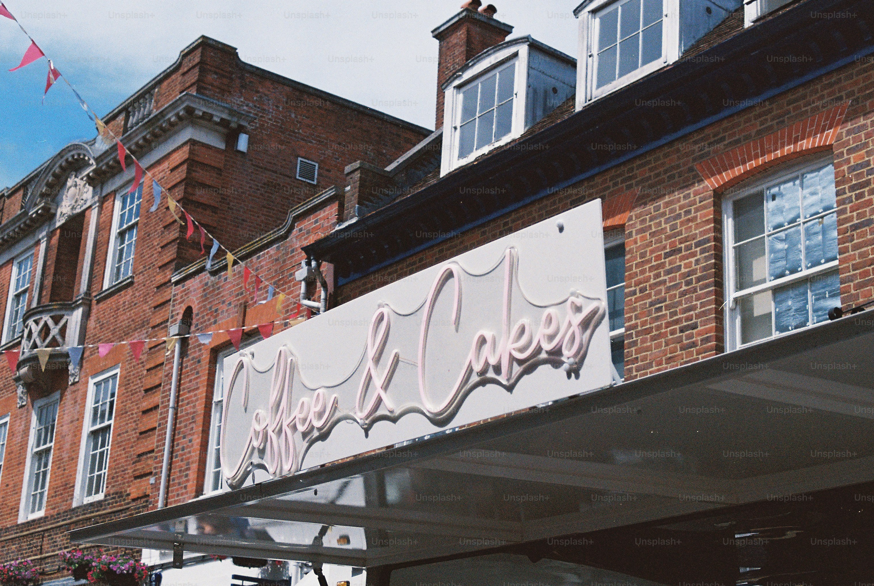 Bakery sign on brick building with festive bunting