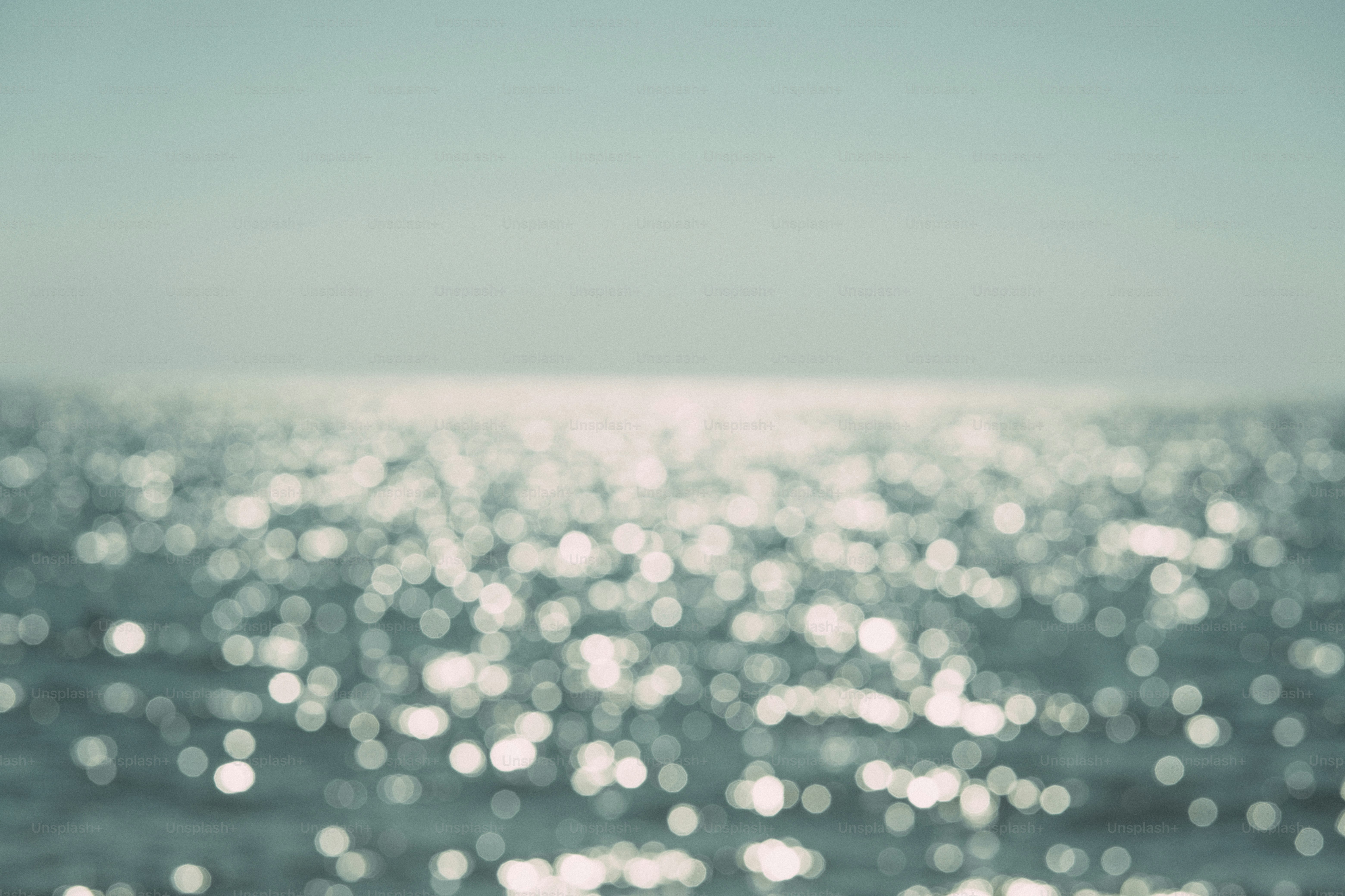 Defocused ocean water with shimmering sunlight reflections