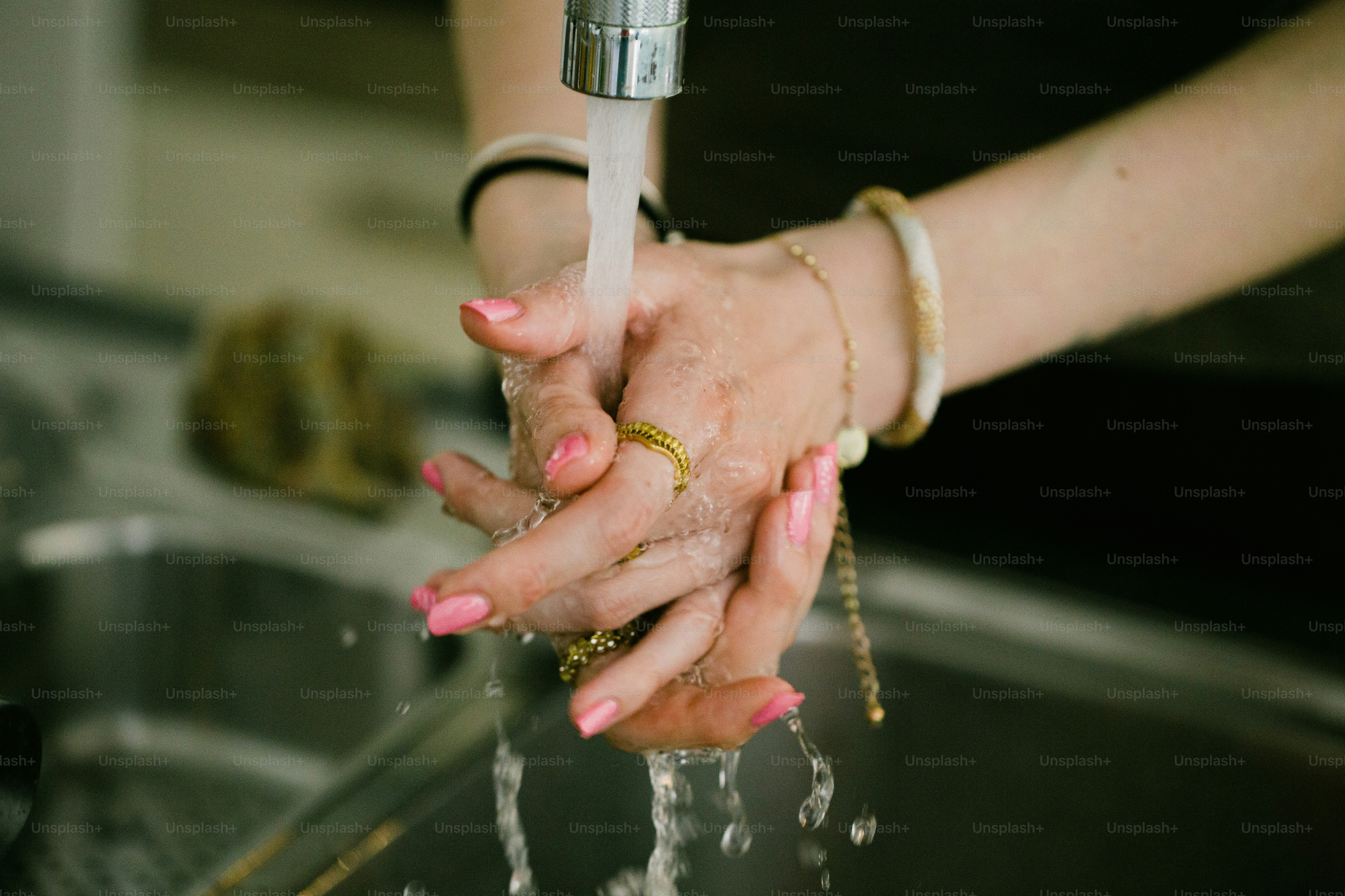 Woman washing hands under running water