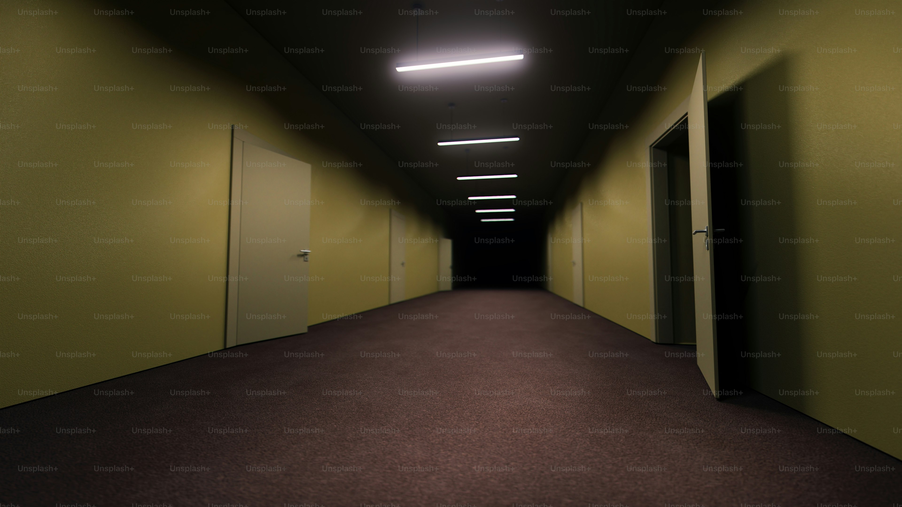 Dimly lit hallway with yellow walls and open door