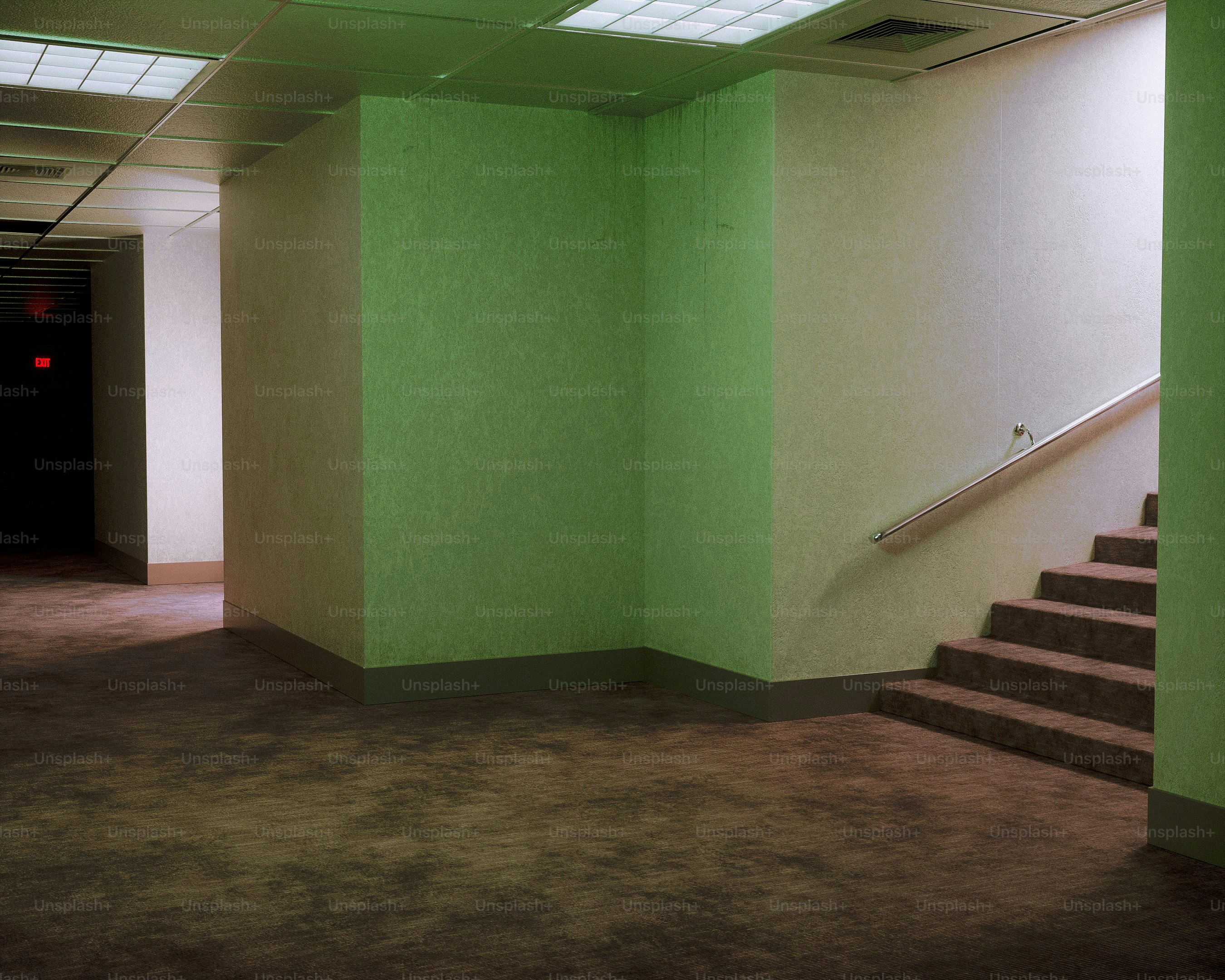Empty, green-tinted liminal space with a staircase
